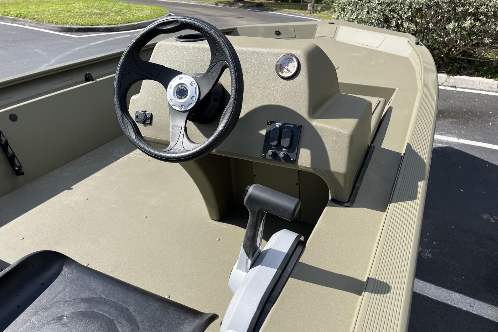 2026 Tracker Grizzly 1754 SC boat interior with steering wheel and control panel.