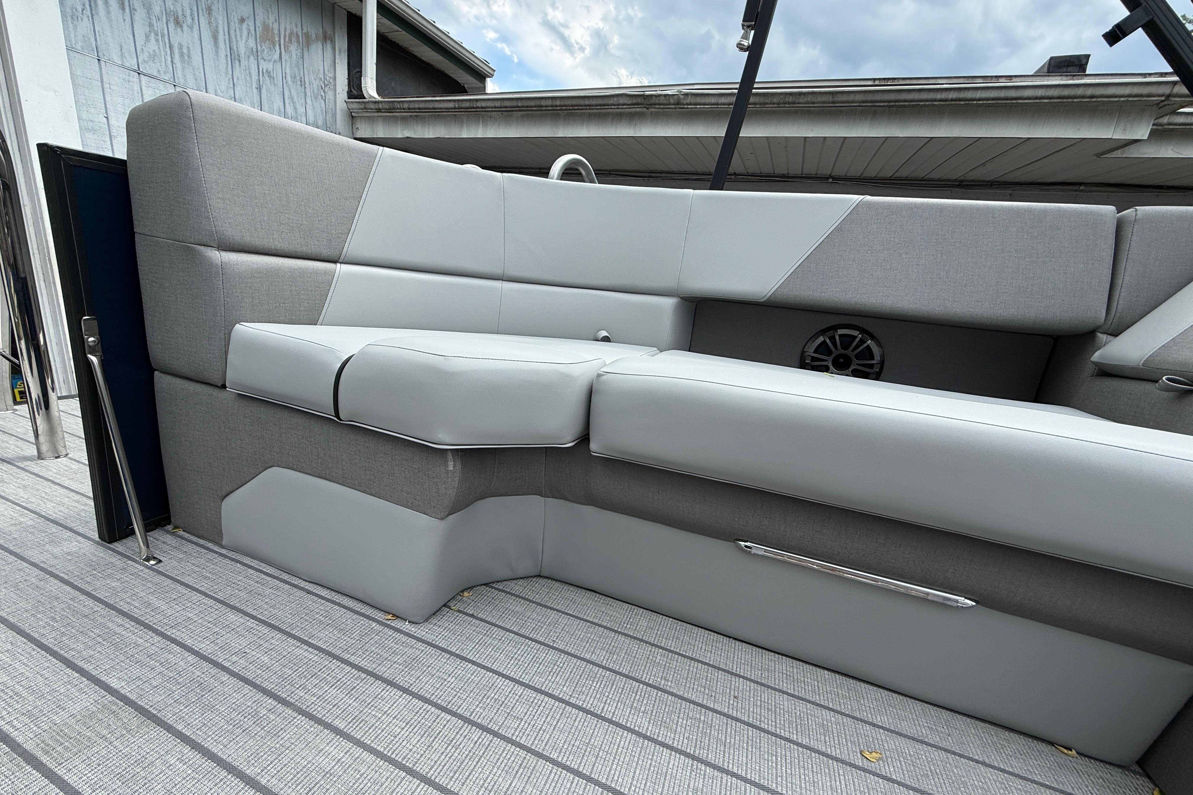 Luxurious seating on 2027 Manitou Aurora RF 23 boat, featuring sleek gray upholstery.