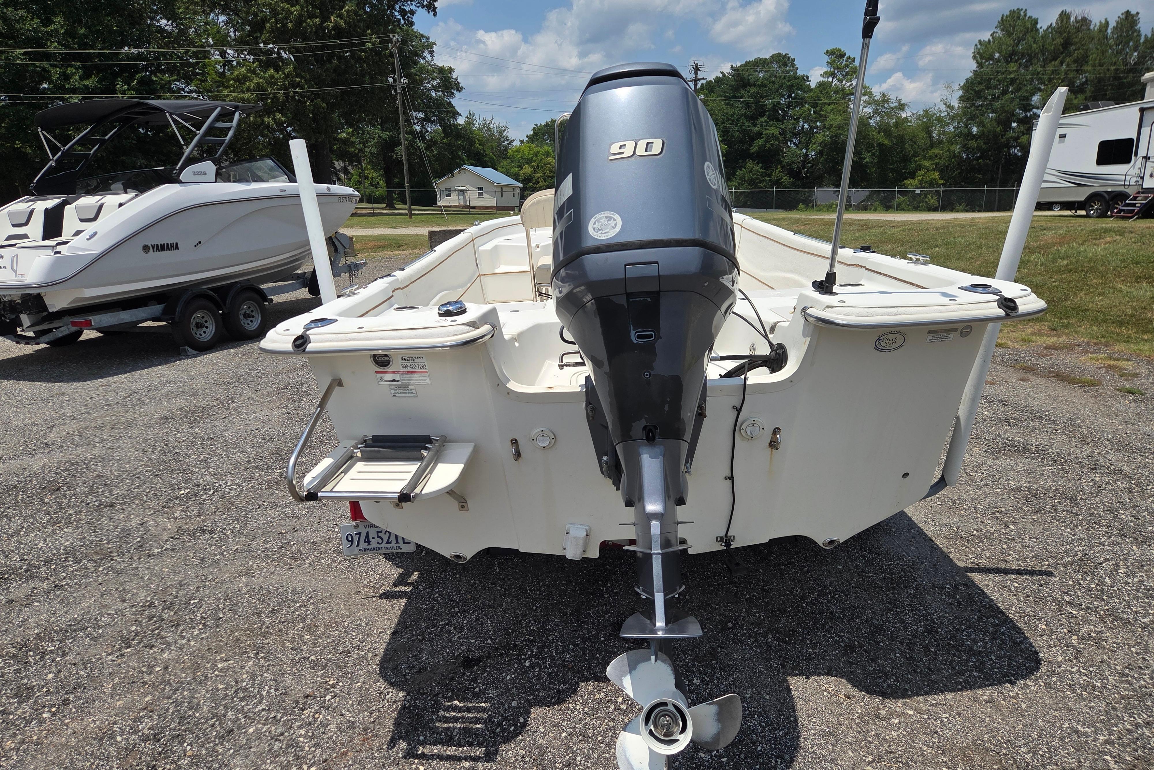2016 Carolina Skiff 198 DLV boat with Yamaha 90 engine, parked outdoors.