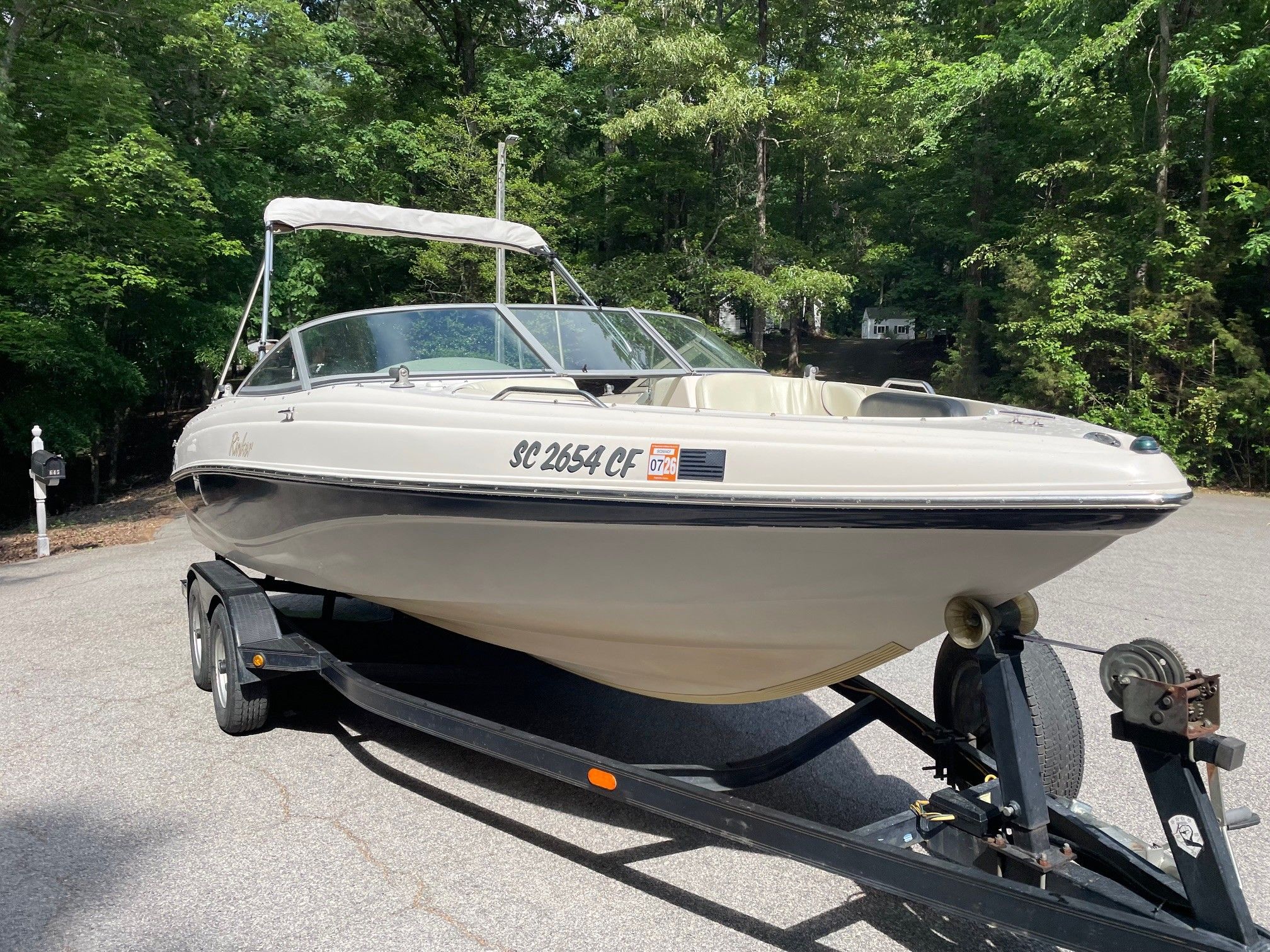 2002 Rinker 212 Captiva Bowrider on trailer outdoors.