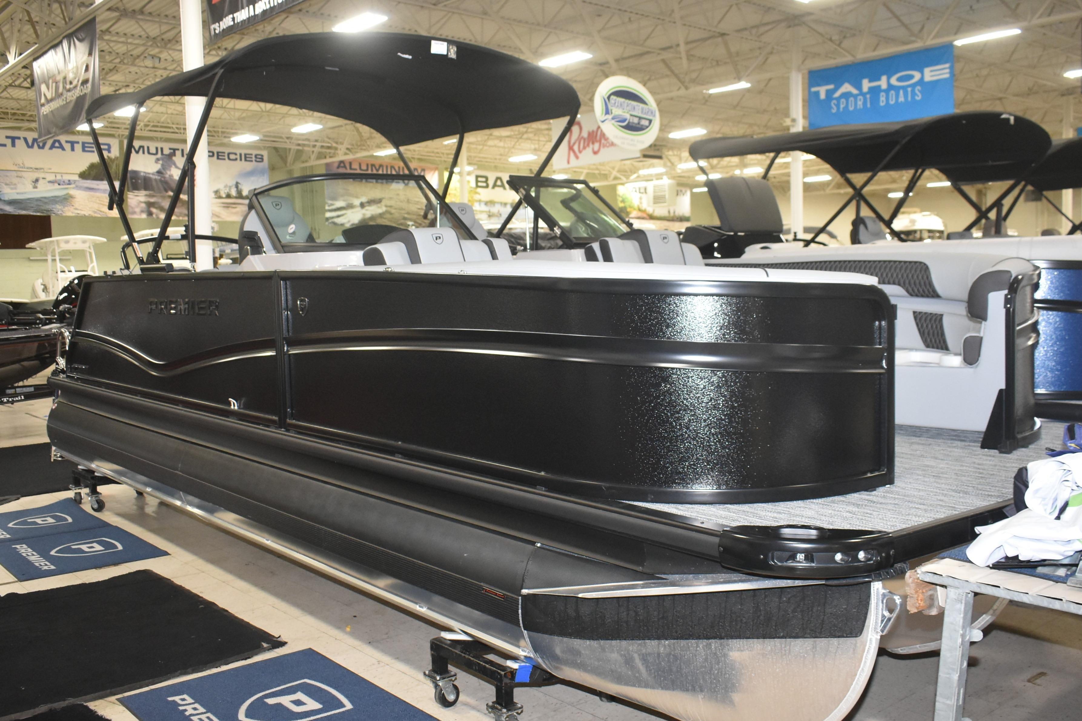 2026 Premier 250 Solaris Sport pontoon boat displayed indoors at a showroom.