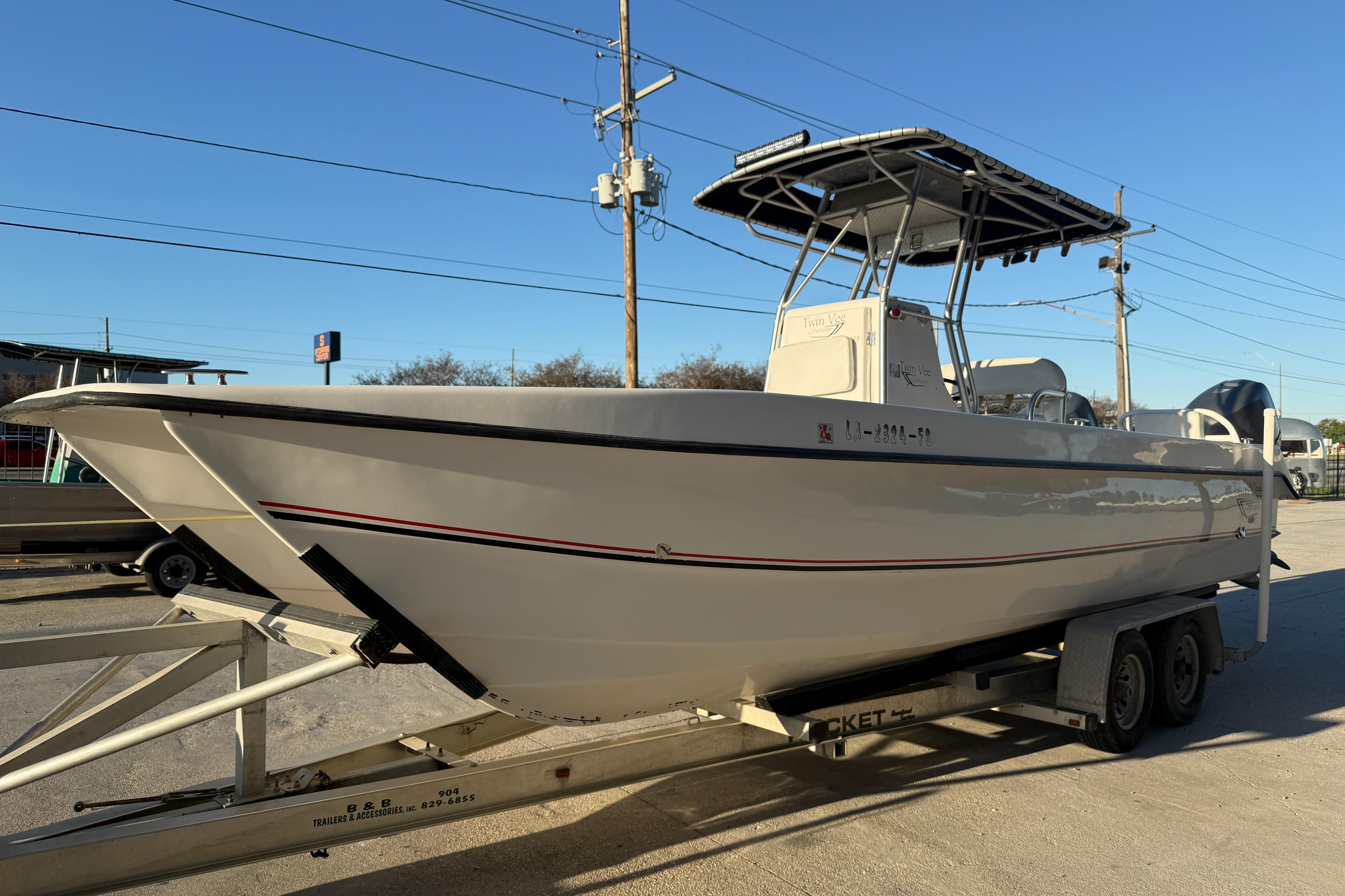 2007 Twin Vee 26 Center Console boat on trailer, parked outdoors.