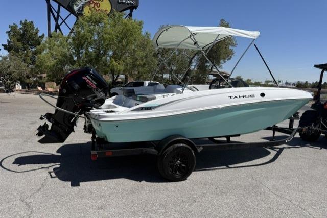 2026 Tahoe T18 boat on trailer with canopy, parked outdoors.