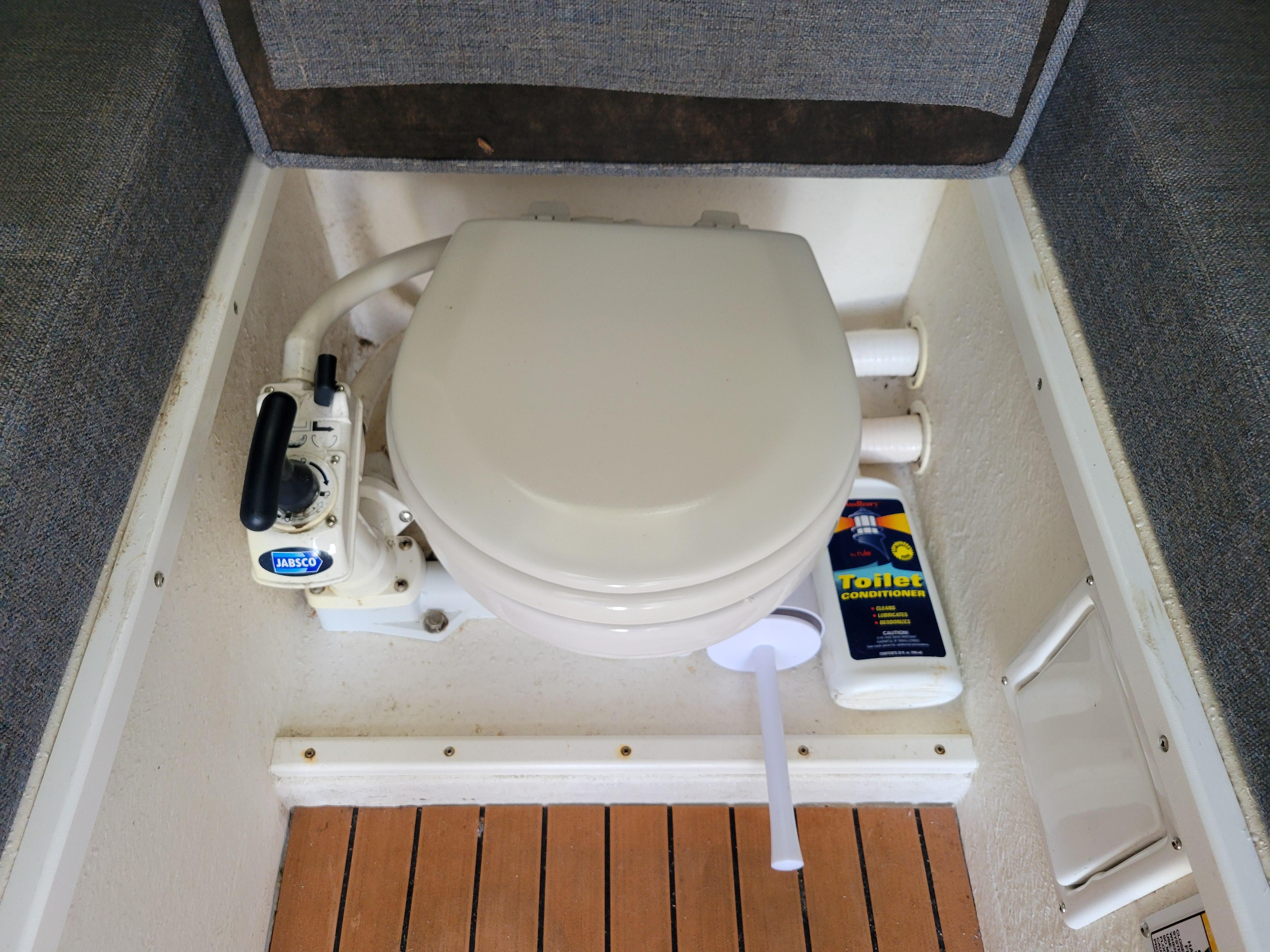 Marine toilet in 1999 SeaSport 2400 XL Limited boat with Jabsco pump and cleaner.