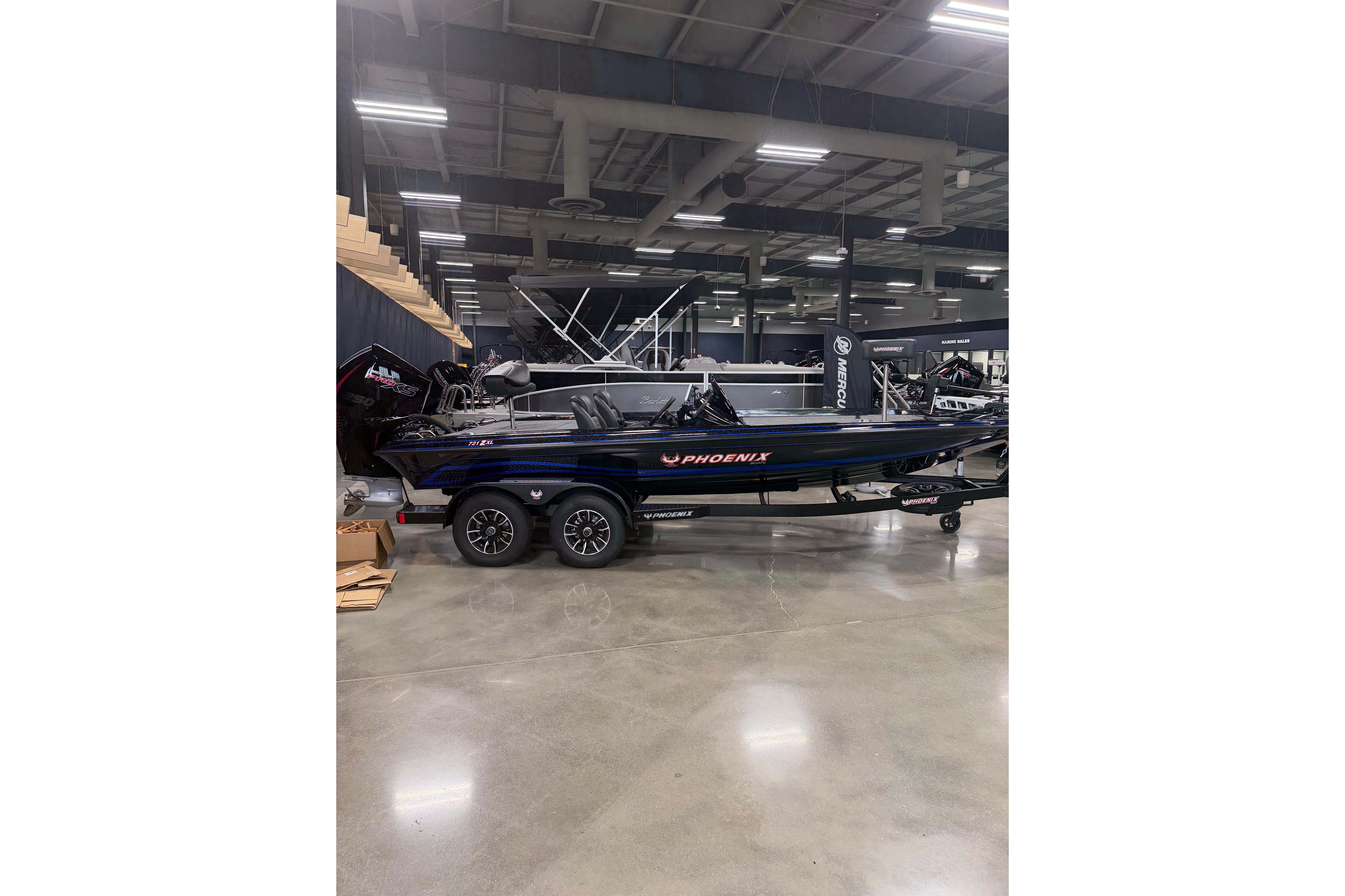 2027 Phoenix 721 ZXL boat displayed indoors on a trailer.