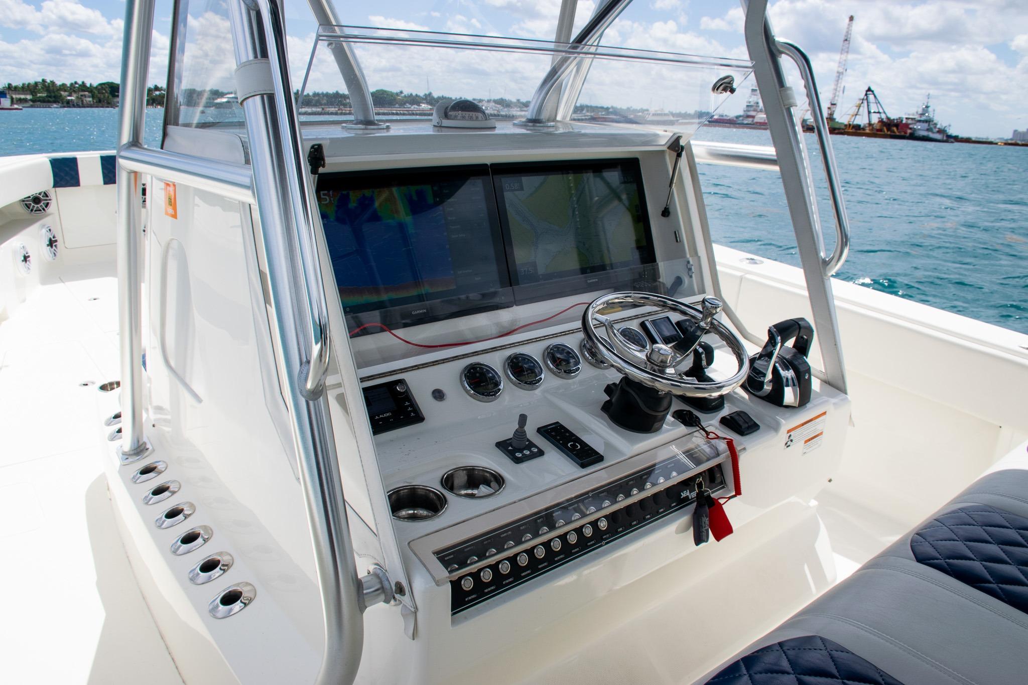 2022 SeaVee 390Z boat dashboard with steering wheel and navigation screens on open water.