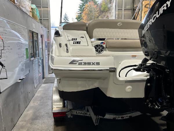 2023 Crownline Eclipse E235 XS boat in a garage, featuring a Mercury engine.