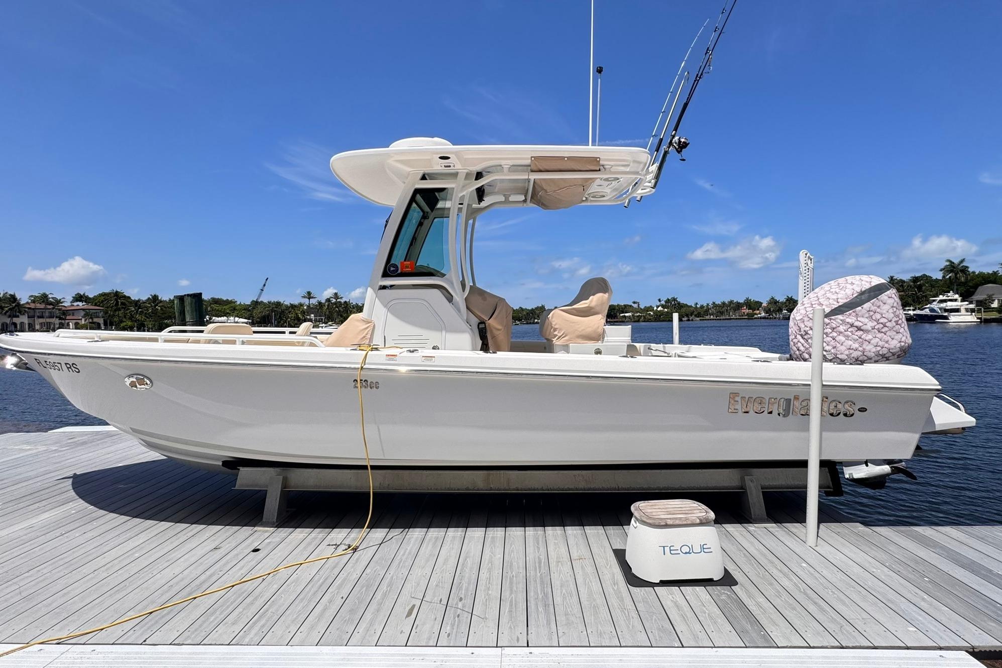 2018 Everglades 253 Center Console boat docked on a sunny day by the water.