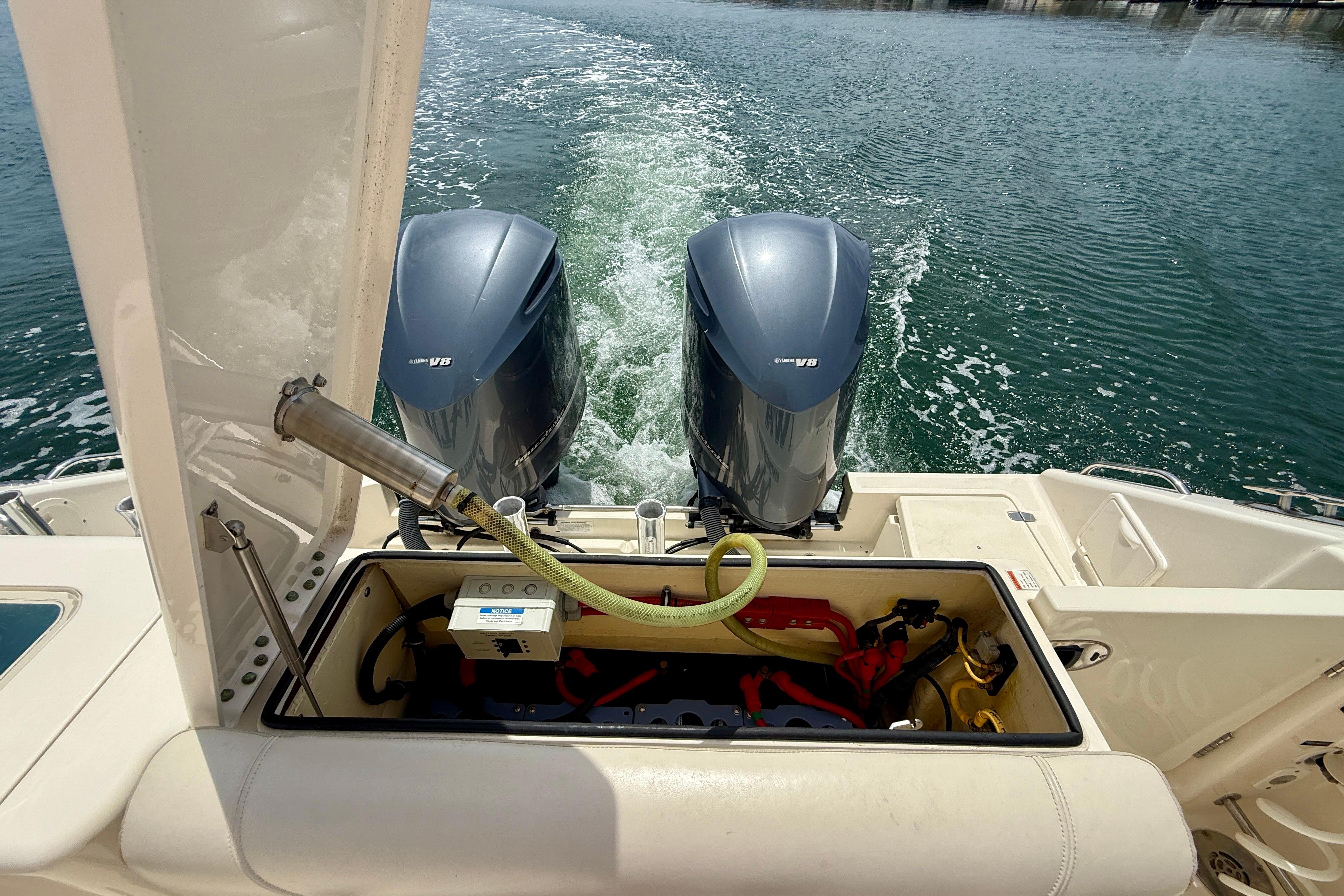 2012 Pursuit OS 345 Offshore boat with dual Yamaha V8 engines on water.