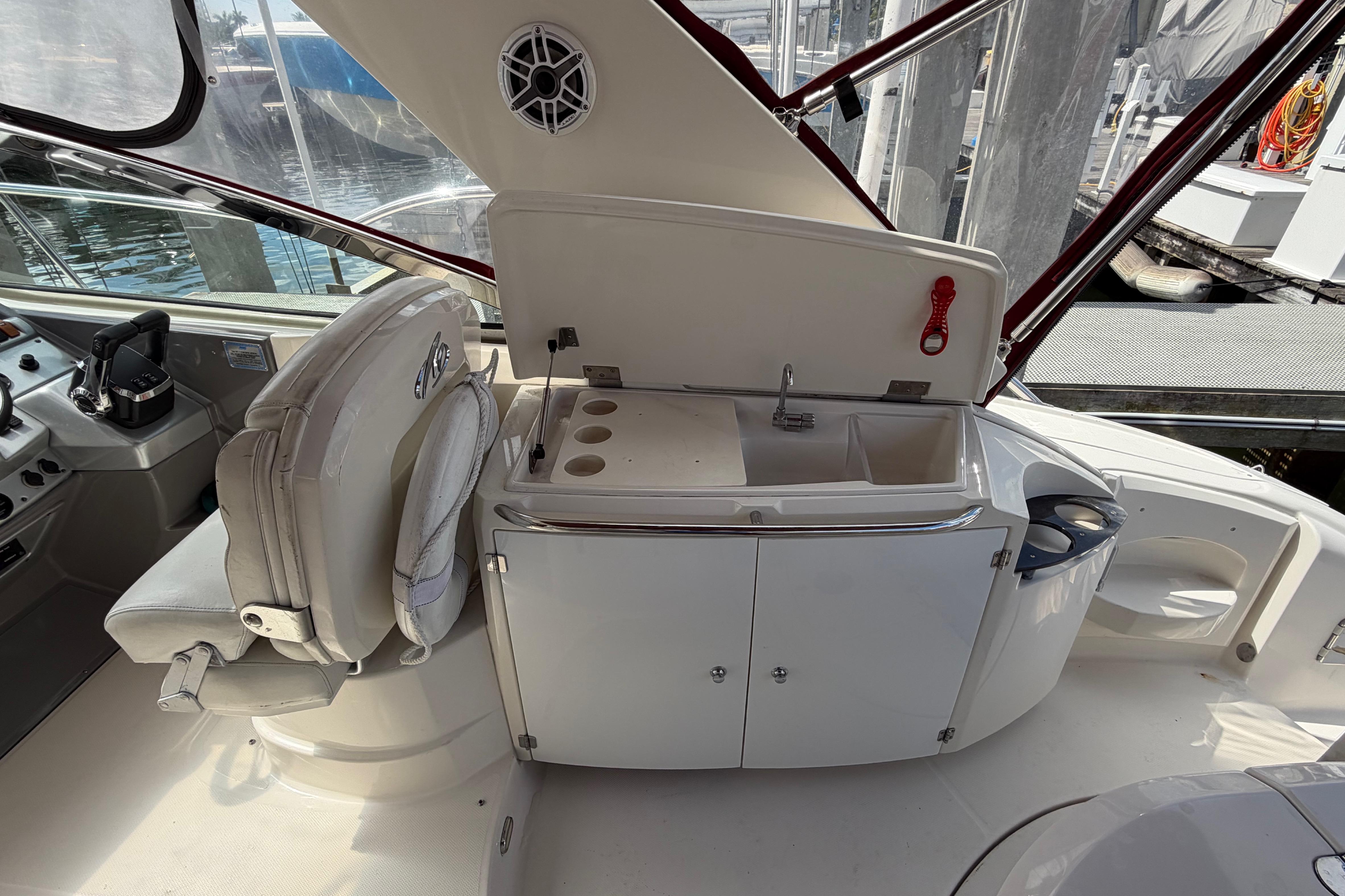 2007 Monterey 350 Sport Yacht interior with helm, sink, and seating area.