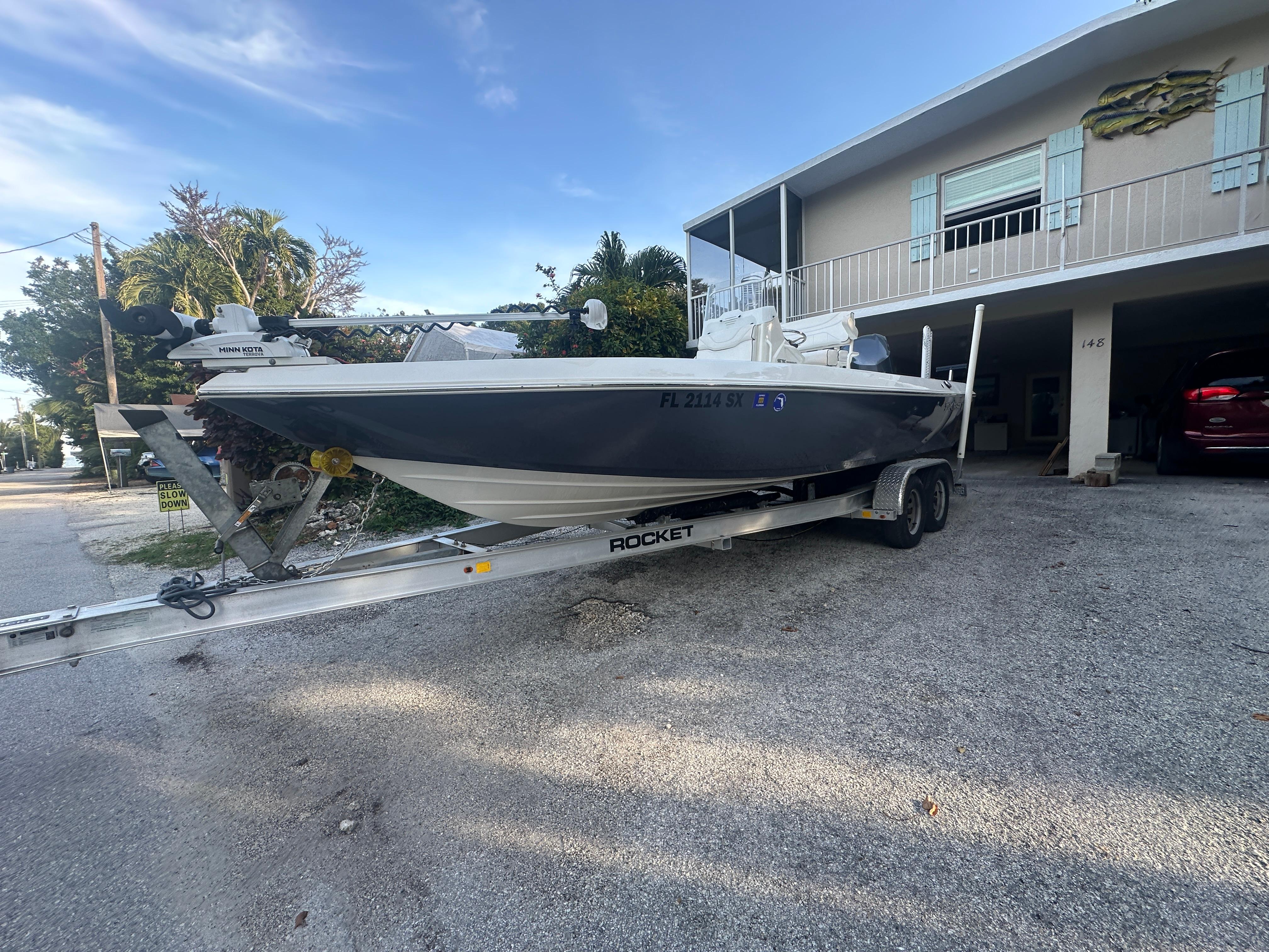 2021 Skeeter SX 2250 boat on a trailer in a driveway.
