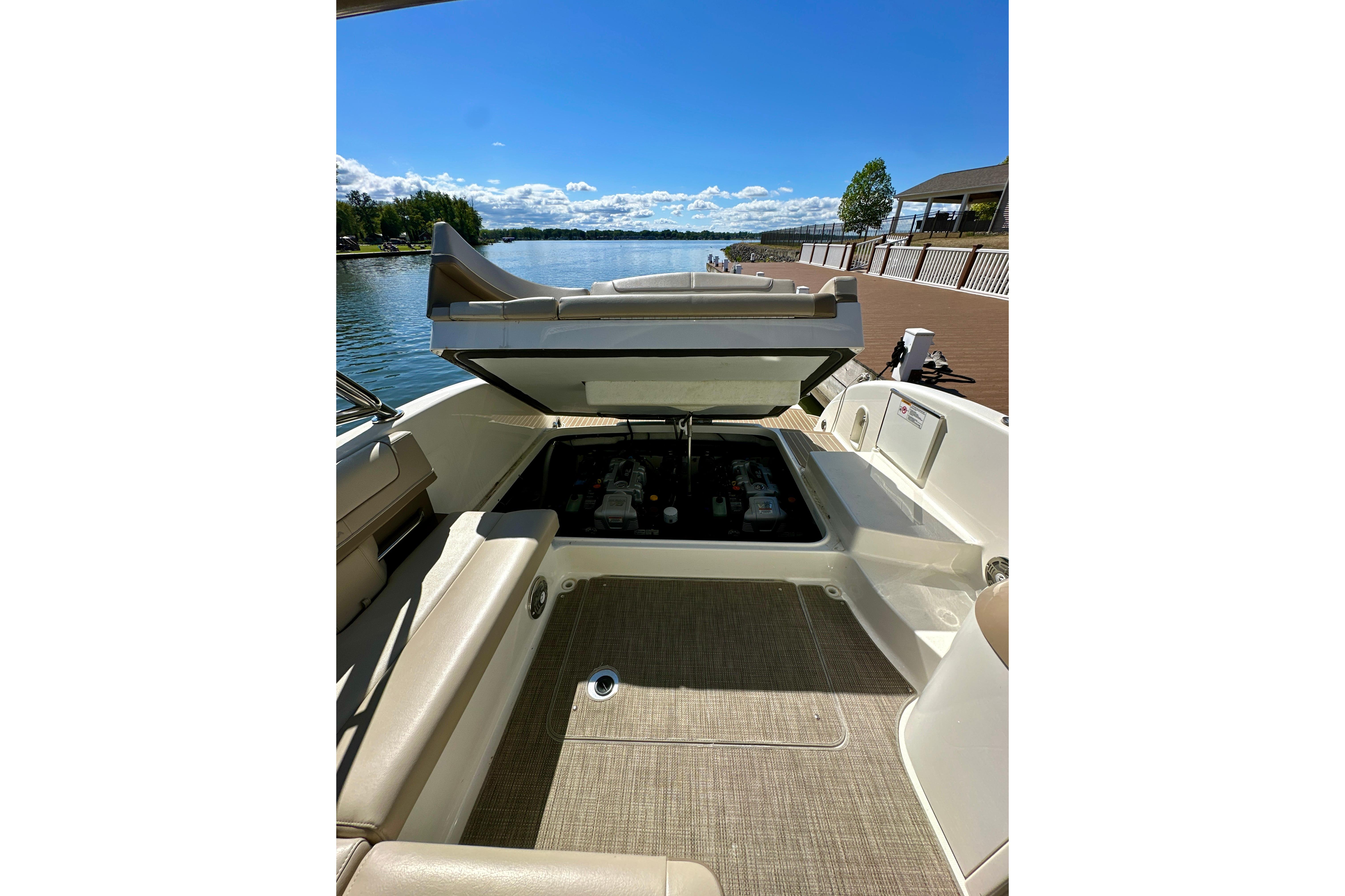 2015 Formula 350 Crossover Bowrider I/O with open engine compartment, docked by a scenic lake.
