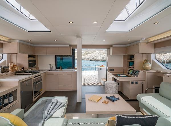 Luxurious interior of 2025 Lagoon 55 yacht with modern kitchen and scenic ocean view.