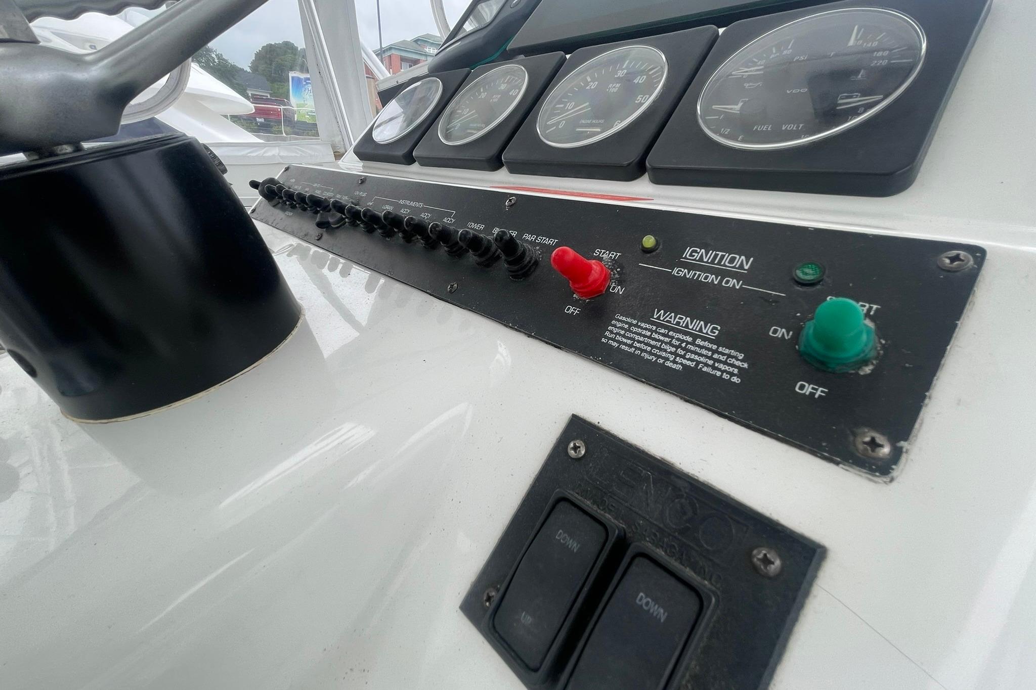 Control panel of a 1996 Luhrs Tournament 290 Open boat with gauges and switches.