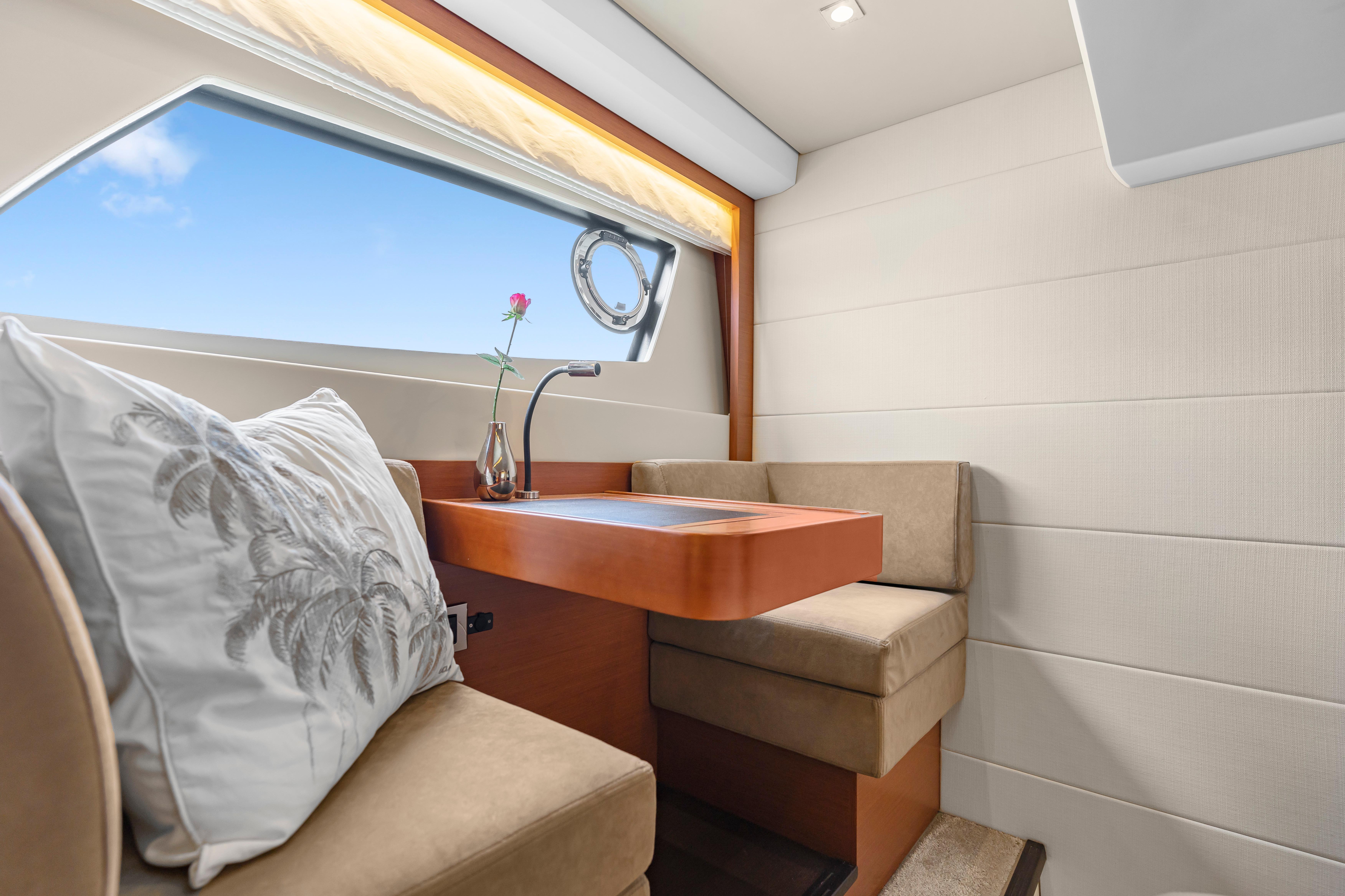 Luxurious interior of 2017 Prestige 500 yacht with elegant seating and window view.