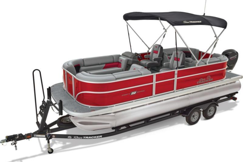 2026 Sun Tracker Party Barge 22 DLX pontoon boat with red and gray seating on a trailer.