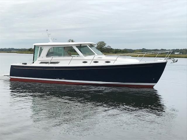 2026 Back Cove 372 boat on calm water, featuring sleek design and modern amenities.