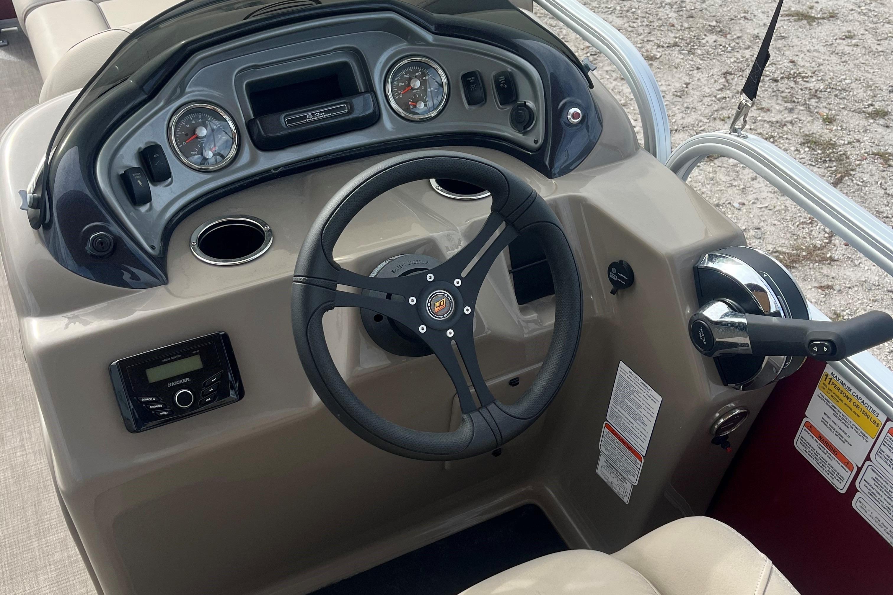 2023 Sun Tracker Party Barge 22 RF DLX dashboard with steering wheel and controls.