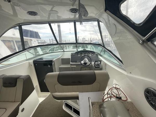 2014 Sea Ray 310 Sundancer boat cockpit with steering wheel and seating.
