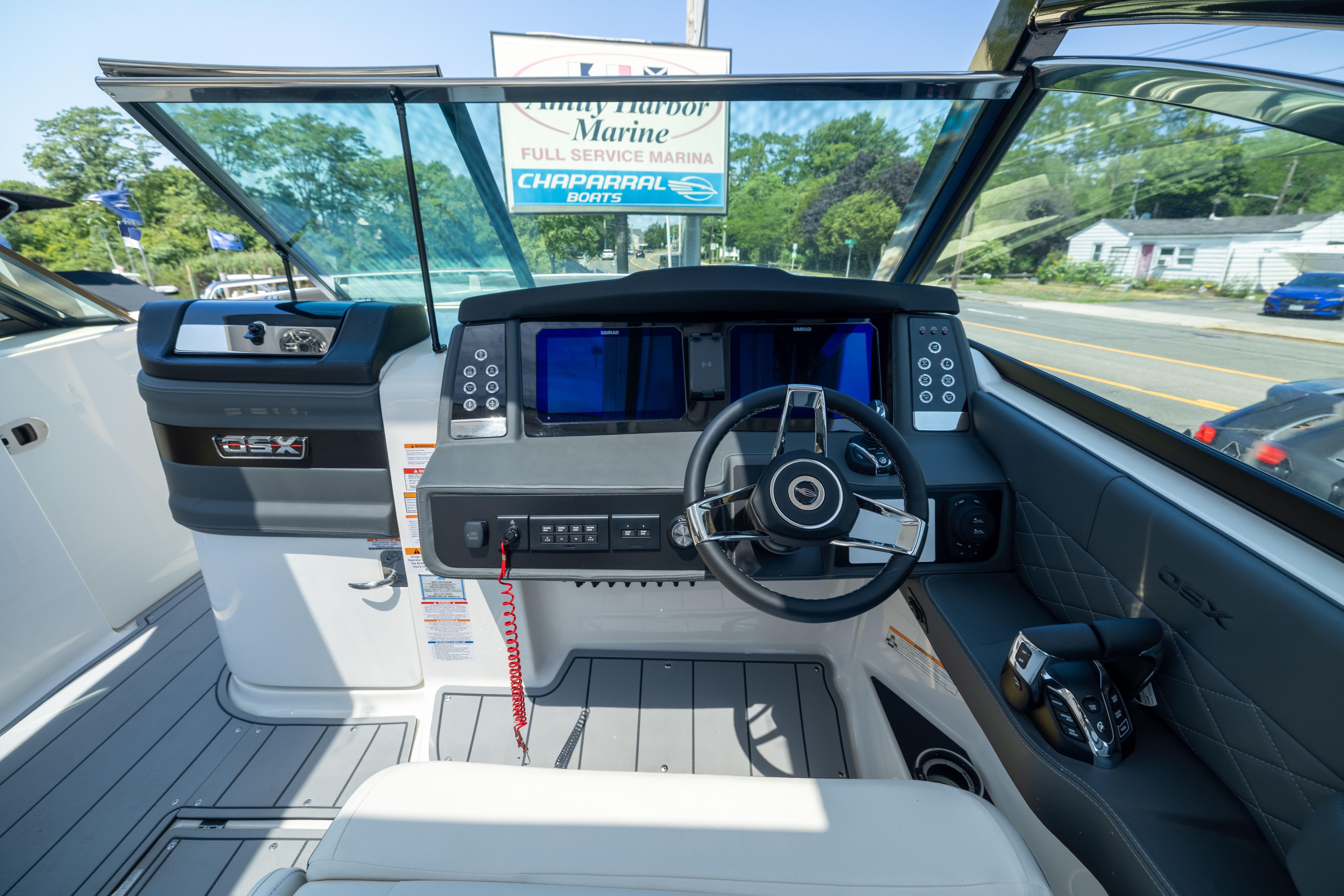 2026 Chaparral 310 OSX boat cockpit with modern steering and control panel.