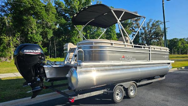 2024 Sun Tracker Party Barge 24 DLX pontoon boat with Mercury outboard motor.
