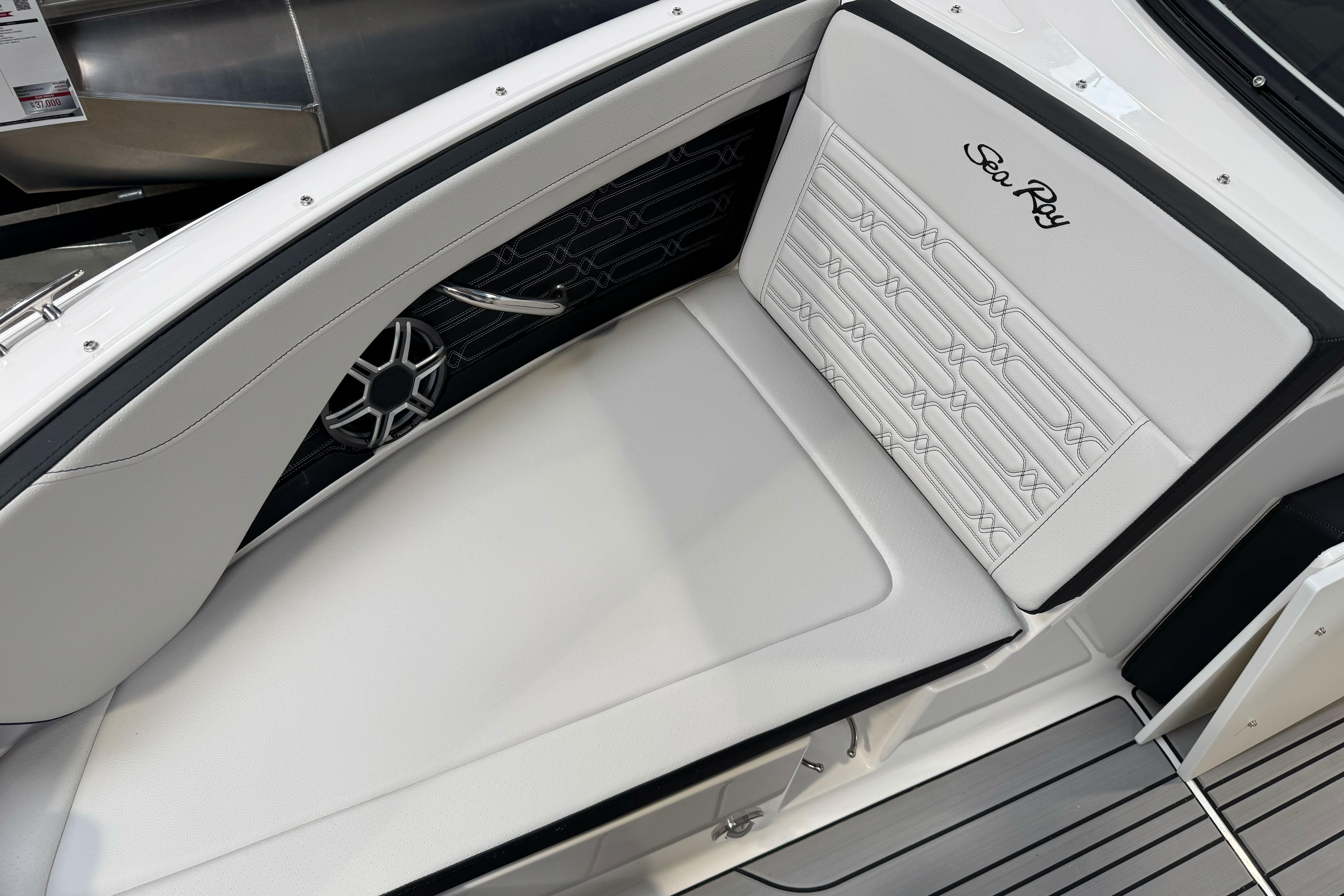 2026 Sea Ray SPX 210 boat interior with white cushioned seating and sleek design.