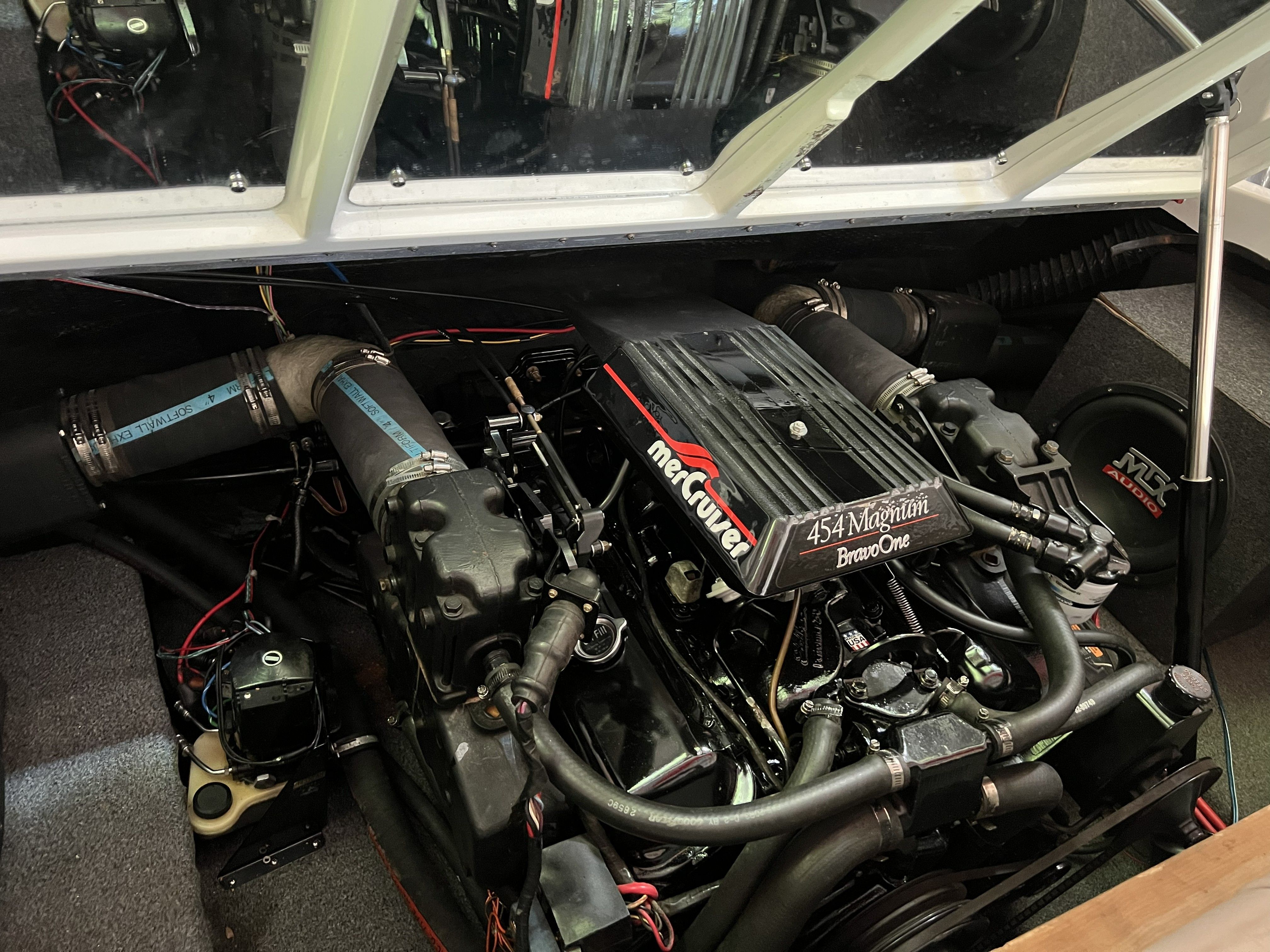 A 1990 Rinker 236 Sport Cuddy engine compartment with a MerCruiser 454 Magnum Bravo One engine.