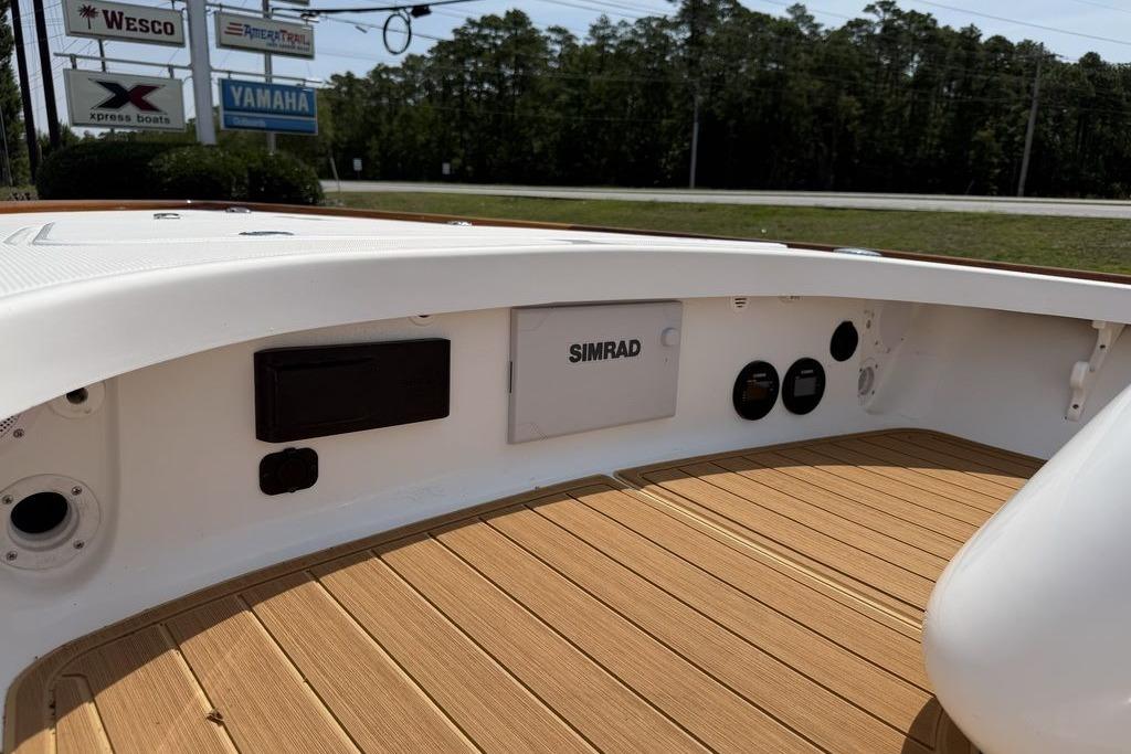 2012 Chaos 16 Bonefish boat interior with Simrad electronics and teak flooring.
