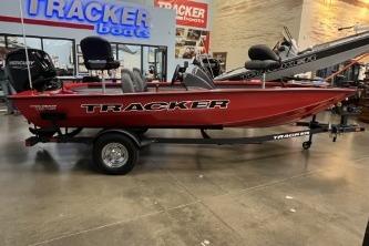 2026 Tracker Pro Team 175 boat displayed in showroom, red exterior, on trailer.