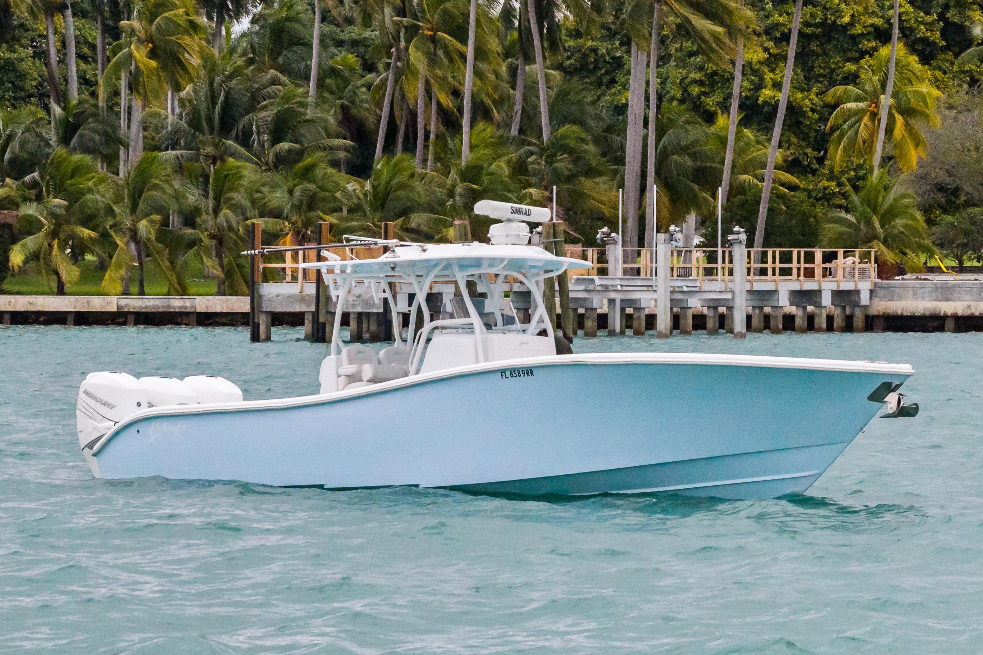 2021 Yellowfin 36 Offshore boat on turquoise water near palm trees.