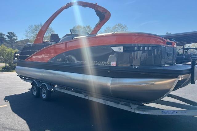 2024 Bennington 23 RXFBA pontoon boat on trailer, featuring sleek design and vibrant colors.