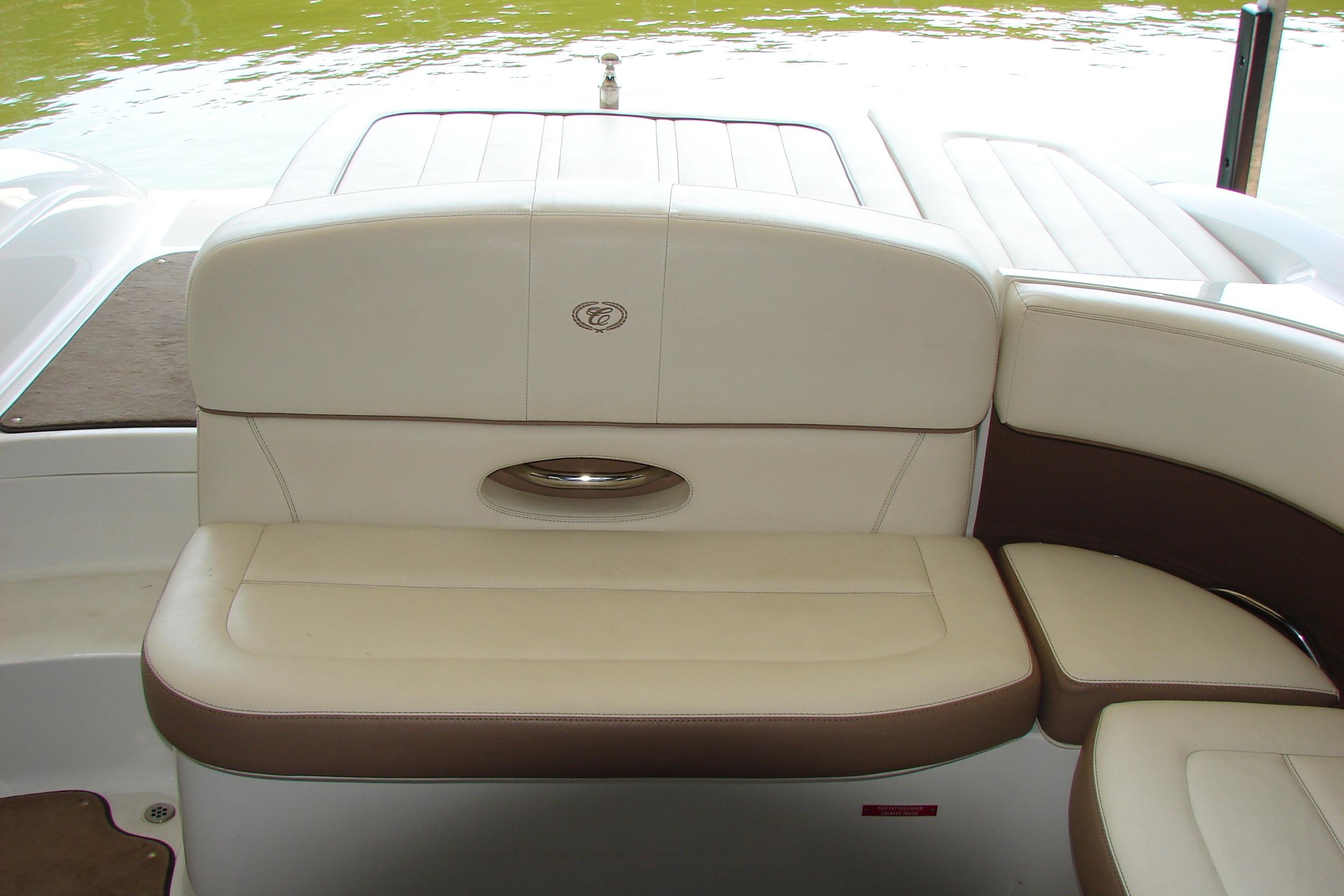 2011 Cobalt 232 boat interior with beige and brown seating near water.