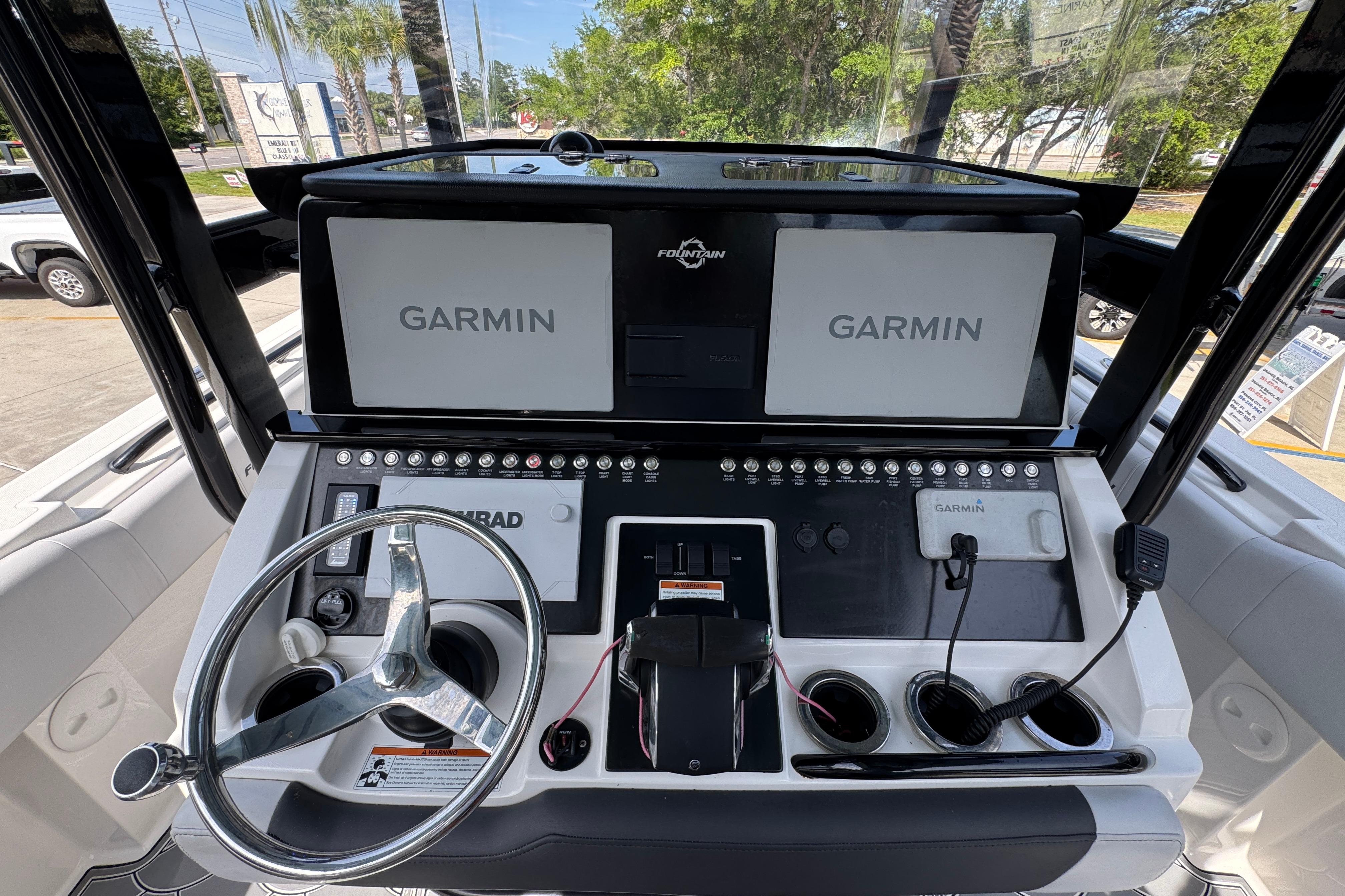 2023 Fountain 34 Tournament Edition boat dashboard with Garmin displays and steering wheel.