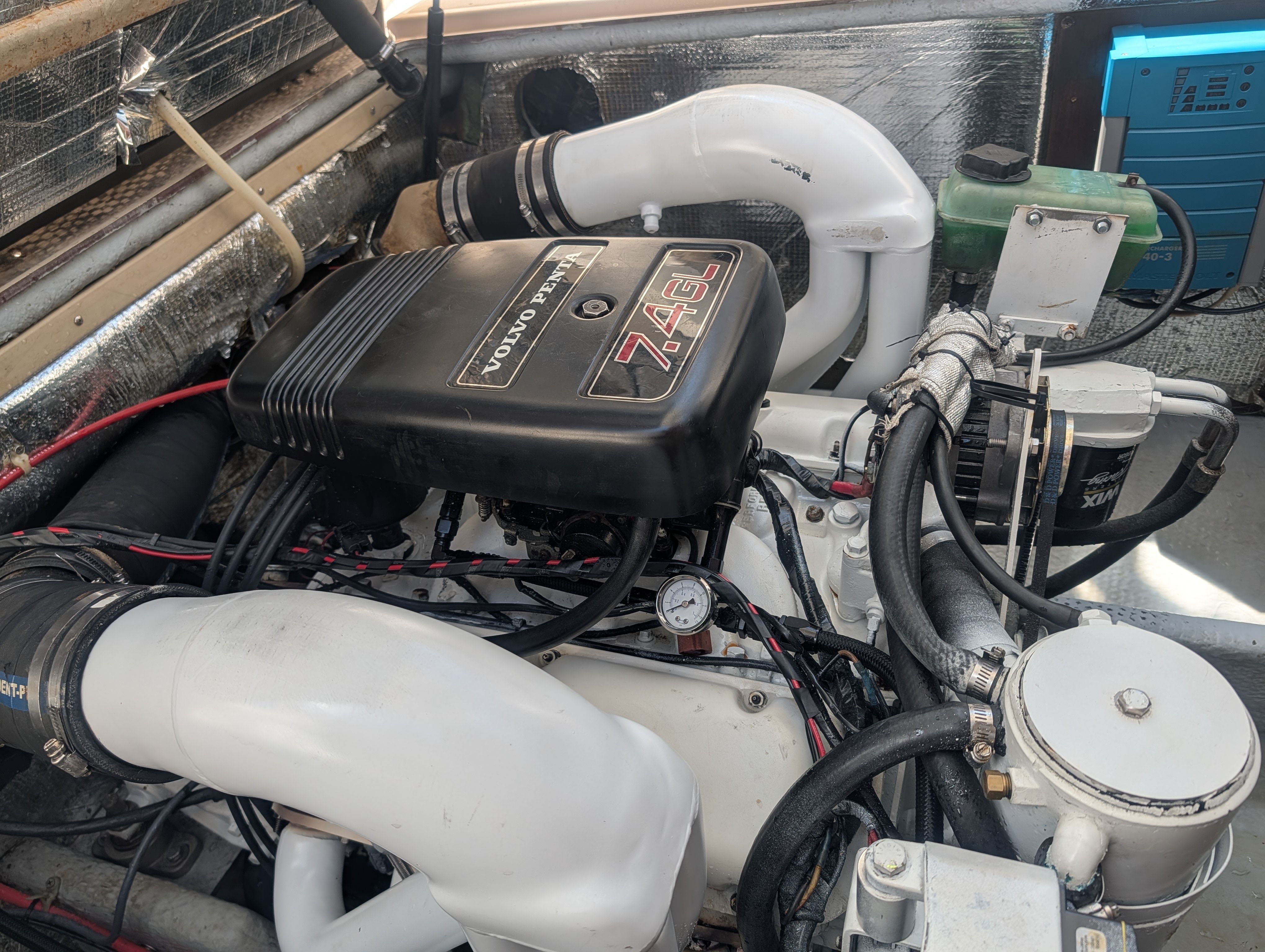 A boat engine labeled Volvo Penta 7.4GL, surrounded by hoses and cables.