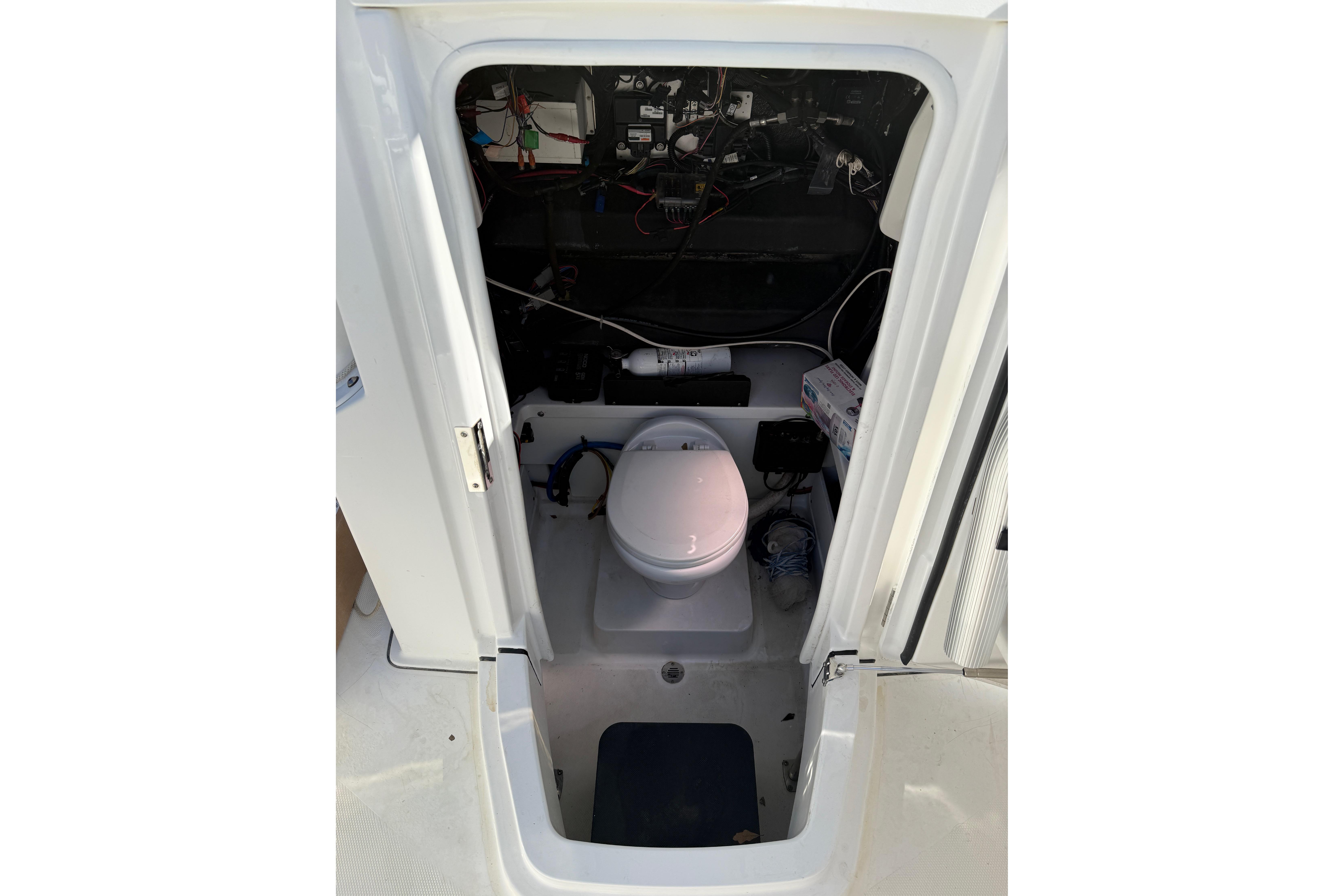 2019 Blackfin 242 CC boat interior with marine toilet and wiring.