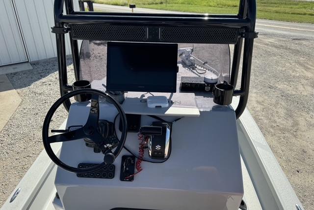 2025 Majek 24 Reaper boat console with steering wheel and navigation screen.