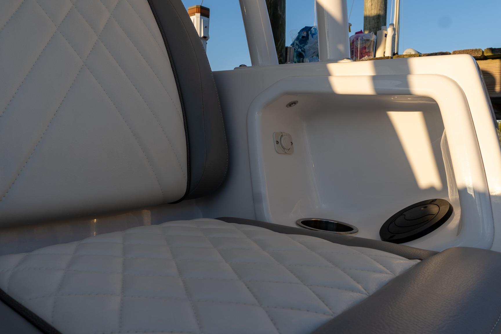 2024 Everglades 395 Center Console interior with quilted seating and storage compartment.