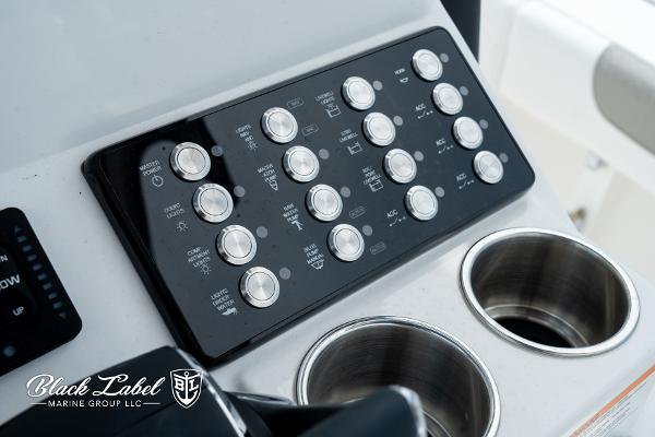 Control panel of 2025 Caymas 281 HB boat with cup holders, Black Label Marine Group logo.