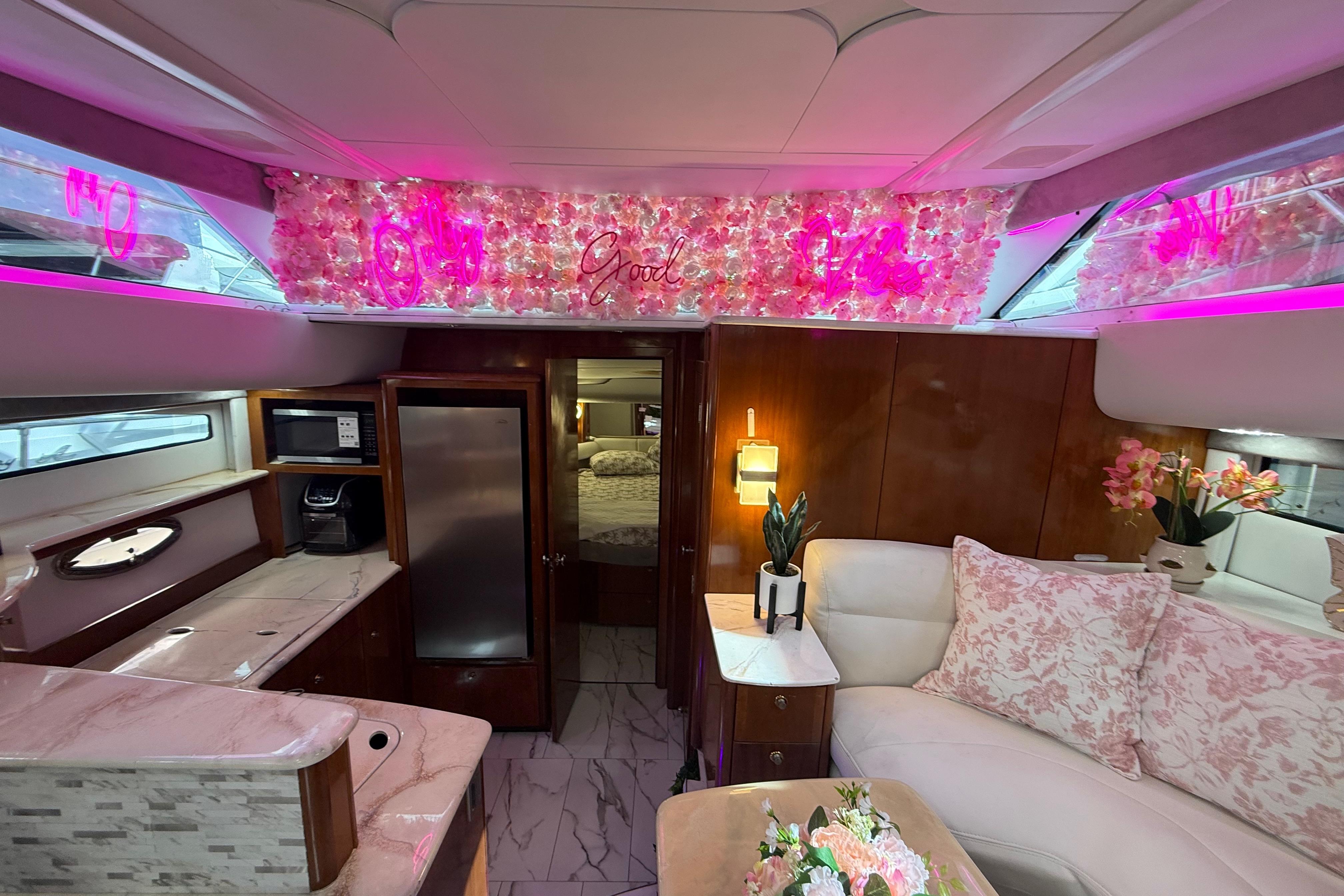 Luxurious 2007 Meridian 459 Motoryacht interior with elegant floral decor and ambient pink lighting.
