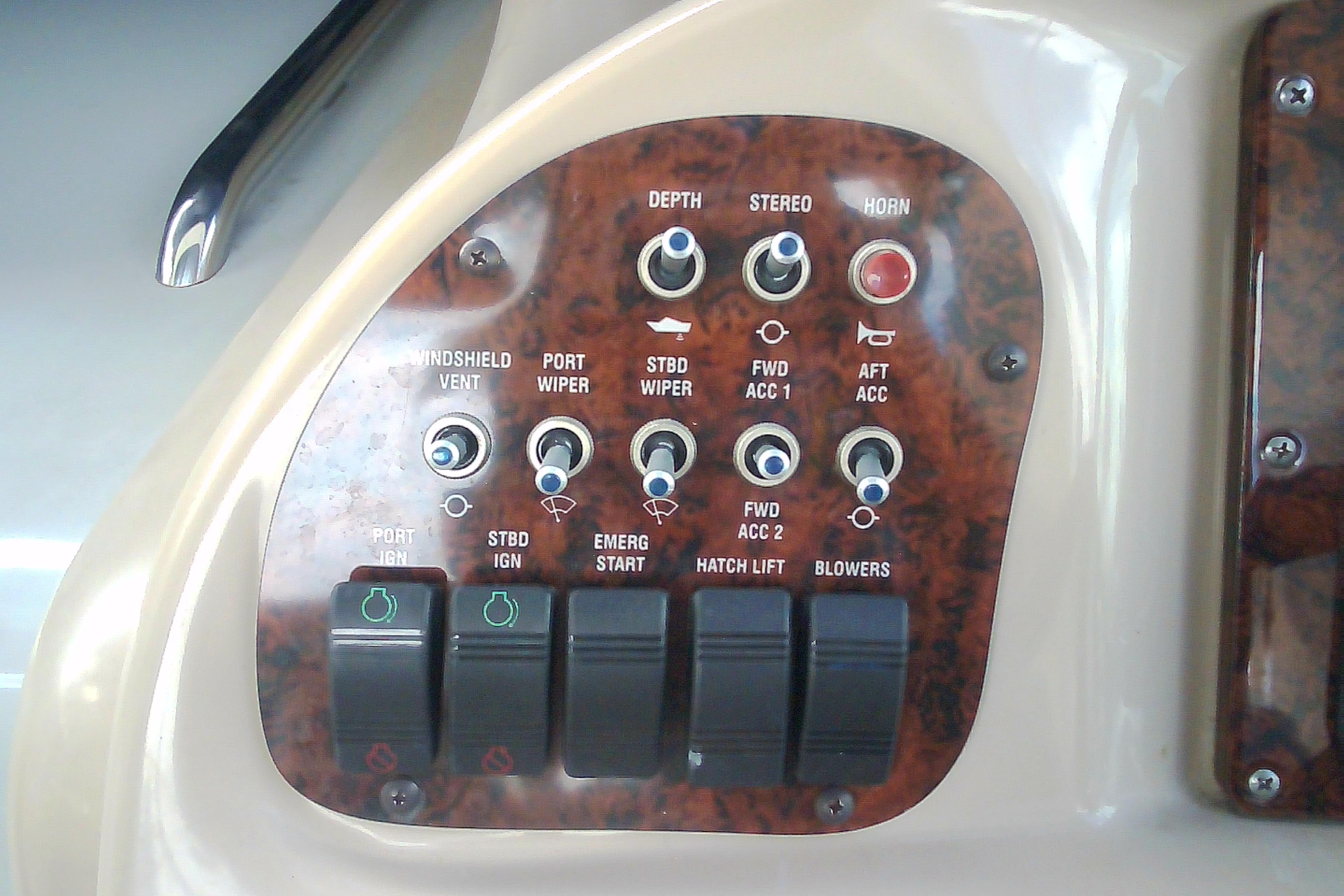 Control panel of a 2005 Sea Ray 300 Sundancer boat with various switches and buttons.