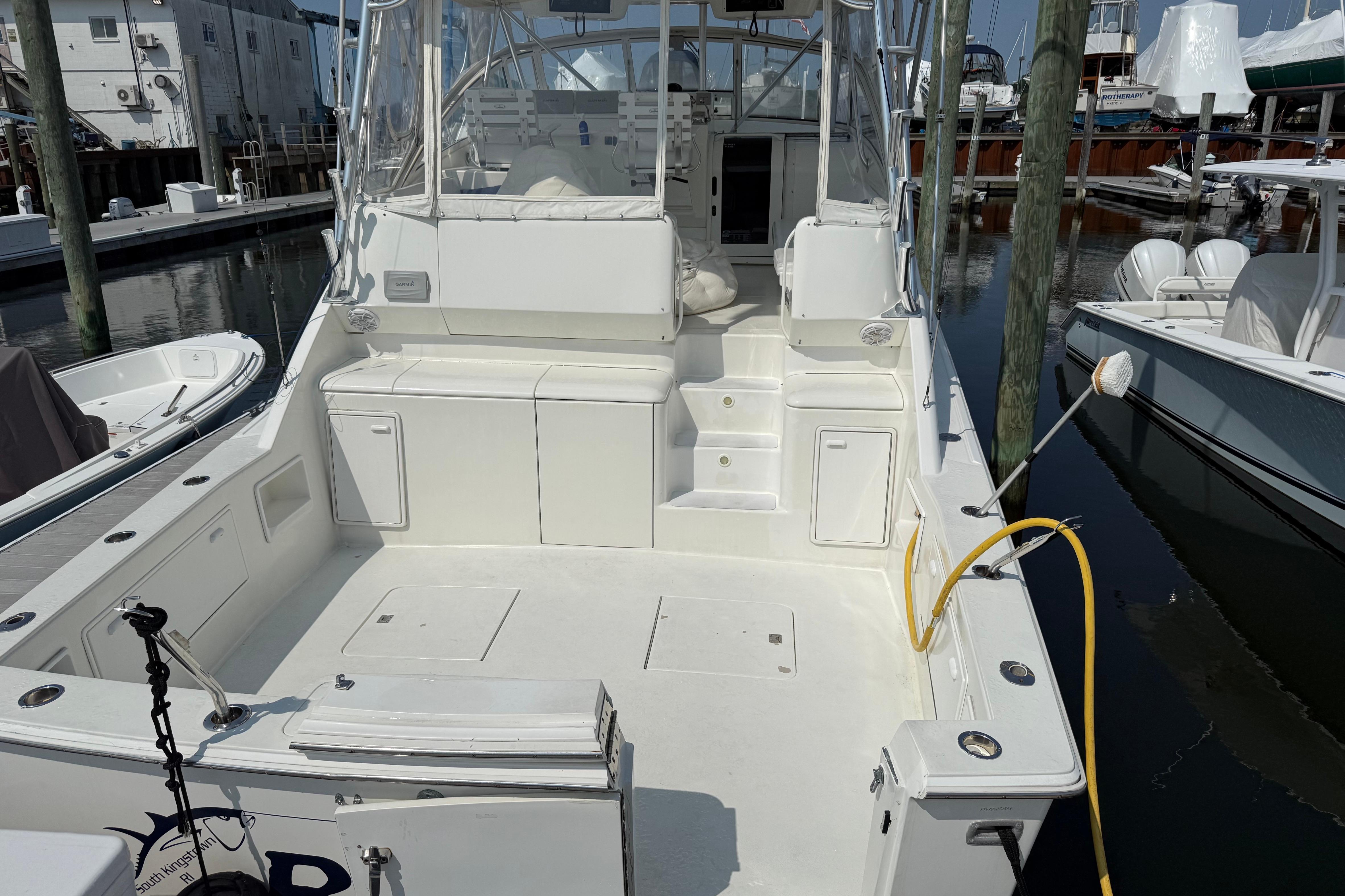 1999 Ocean Yachts 40 Express boat docked, featuring spacious deck and seating area.