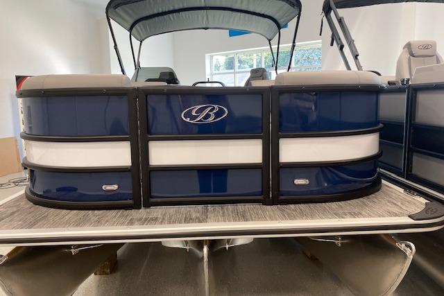 2026 Bentley Pontoons Legacy 243 Swingback, blue and white design, in showroom.