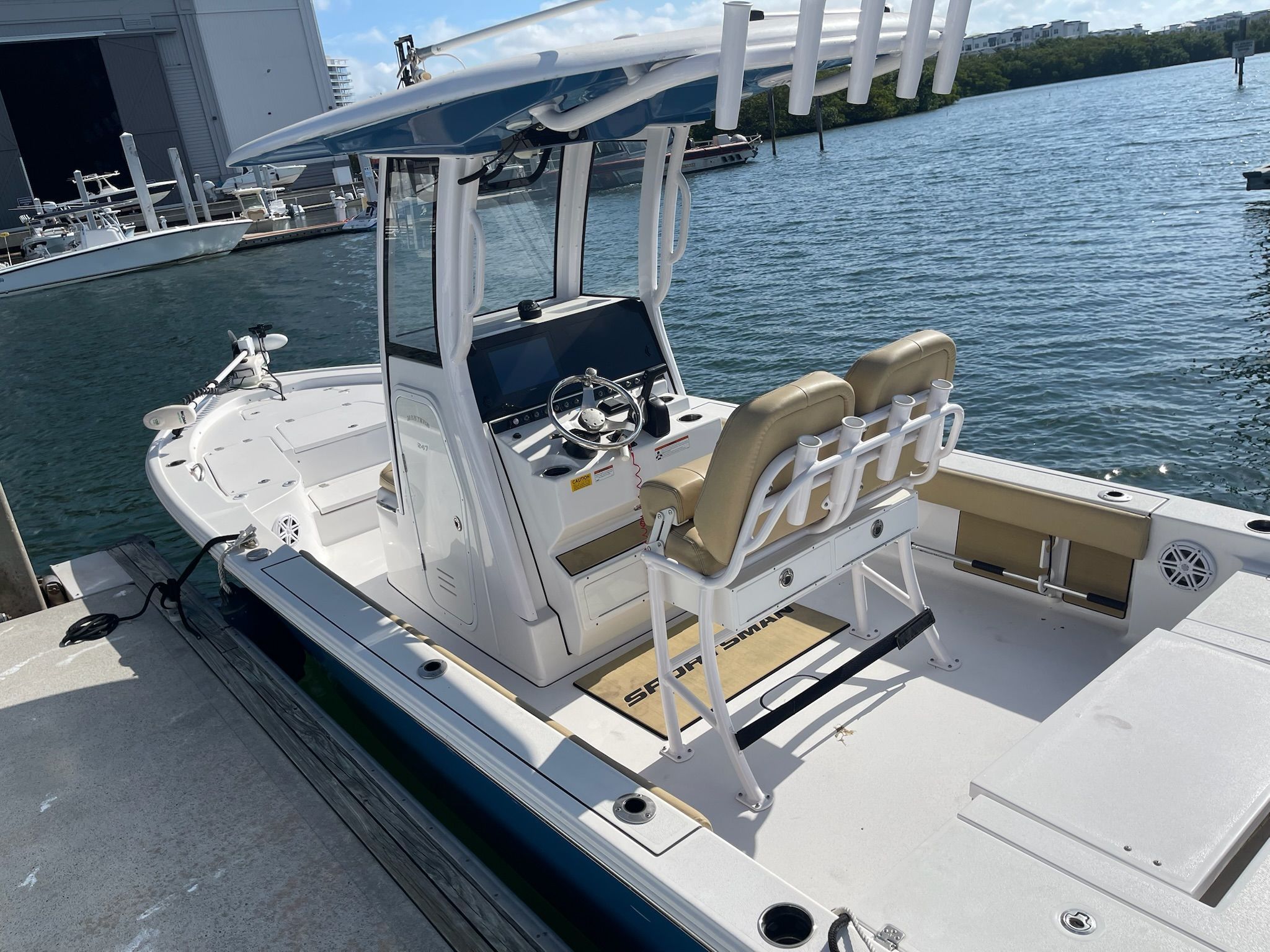 2022 Sportsman Masters 247 Bay Boat docked with blue water in the background.