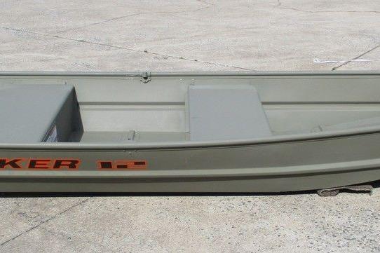 2023 Tracker Grizzly 1236 Jon boat on concrete surface, side view.