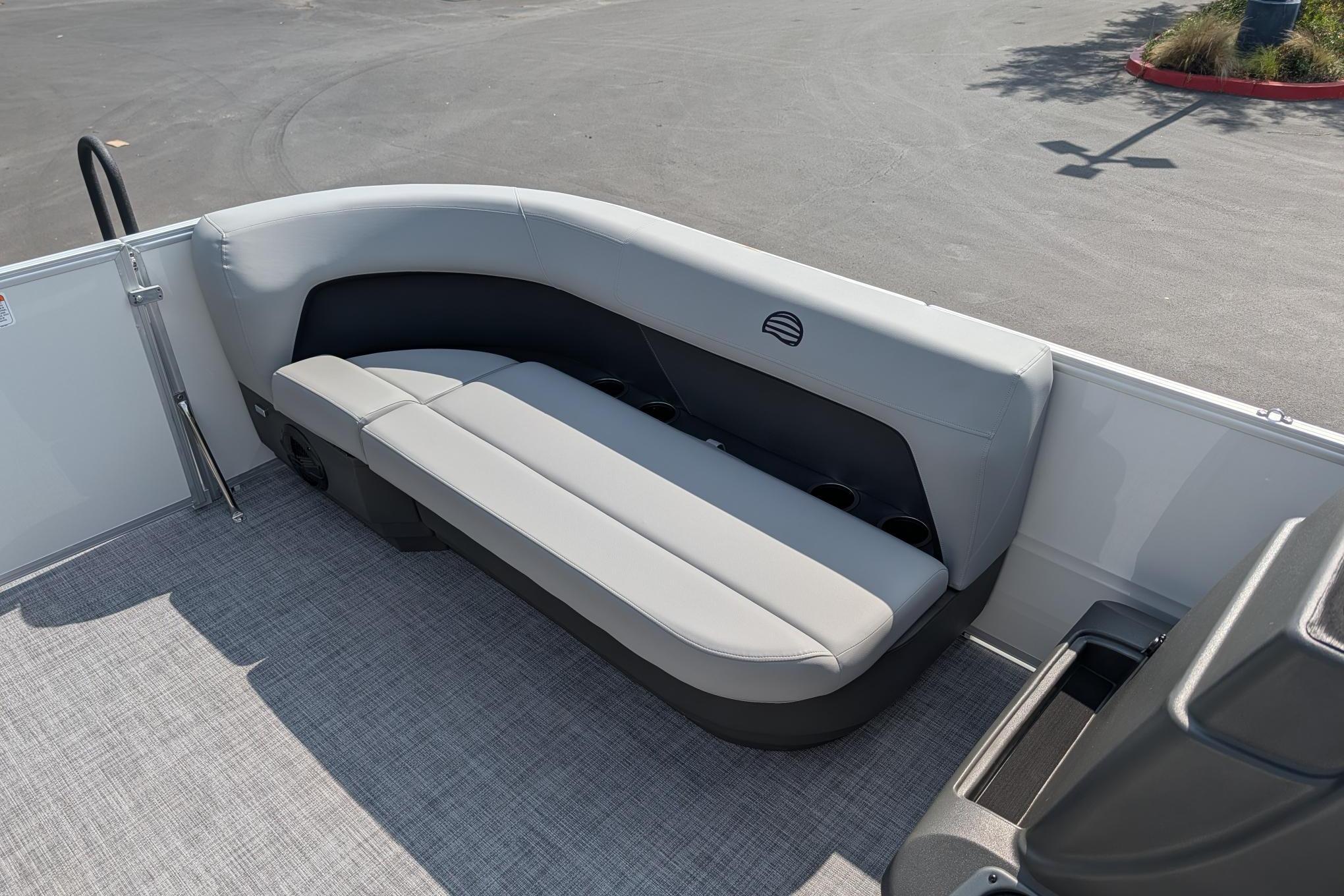 2026 Sun Tracker Party Barge 16 DLX interior seating with gray upholstery and cup holders.