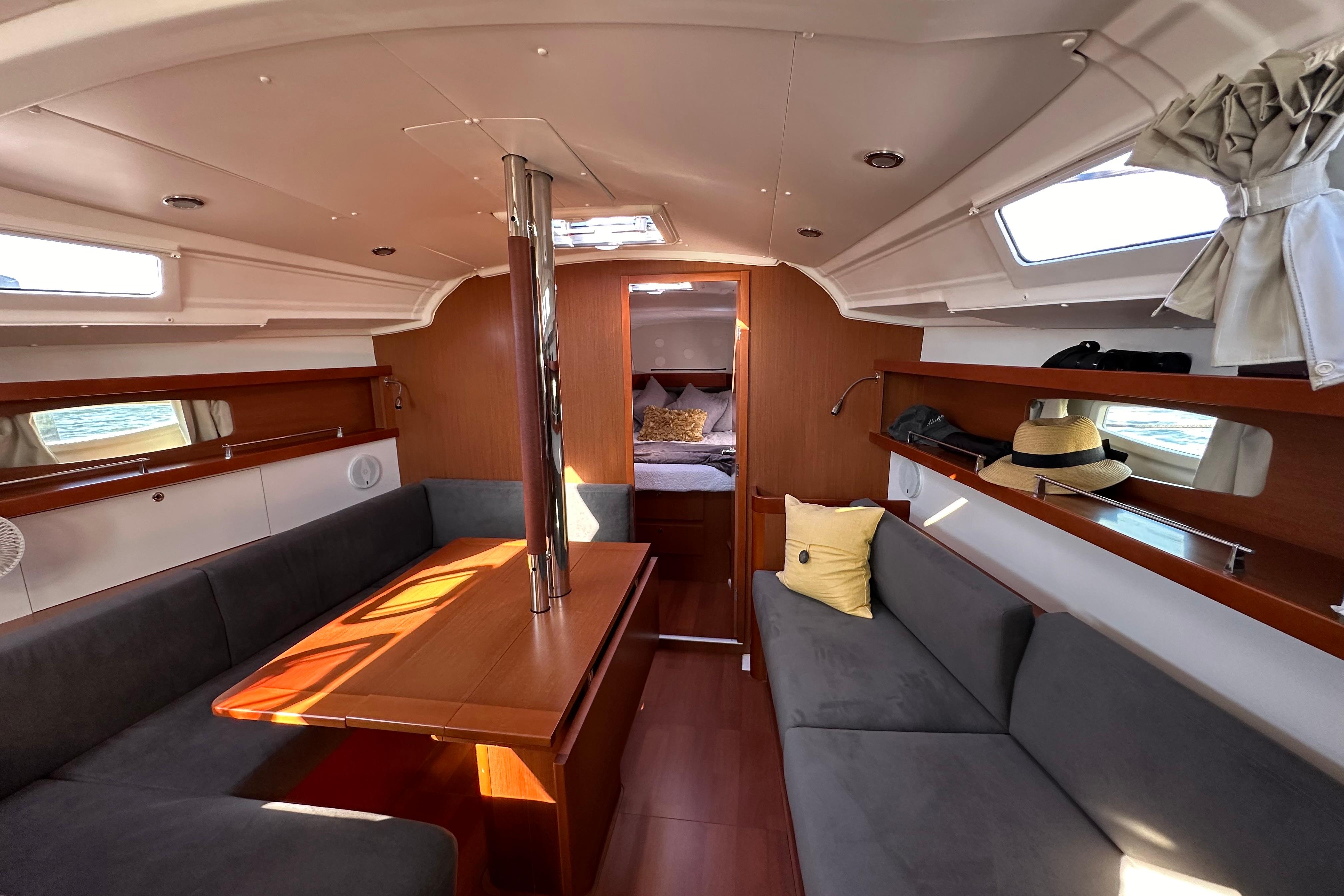 Interior of 2015 Beneteau Oceanis 37 sailboat with cozy seating and wooden finishes.