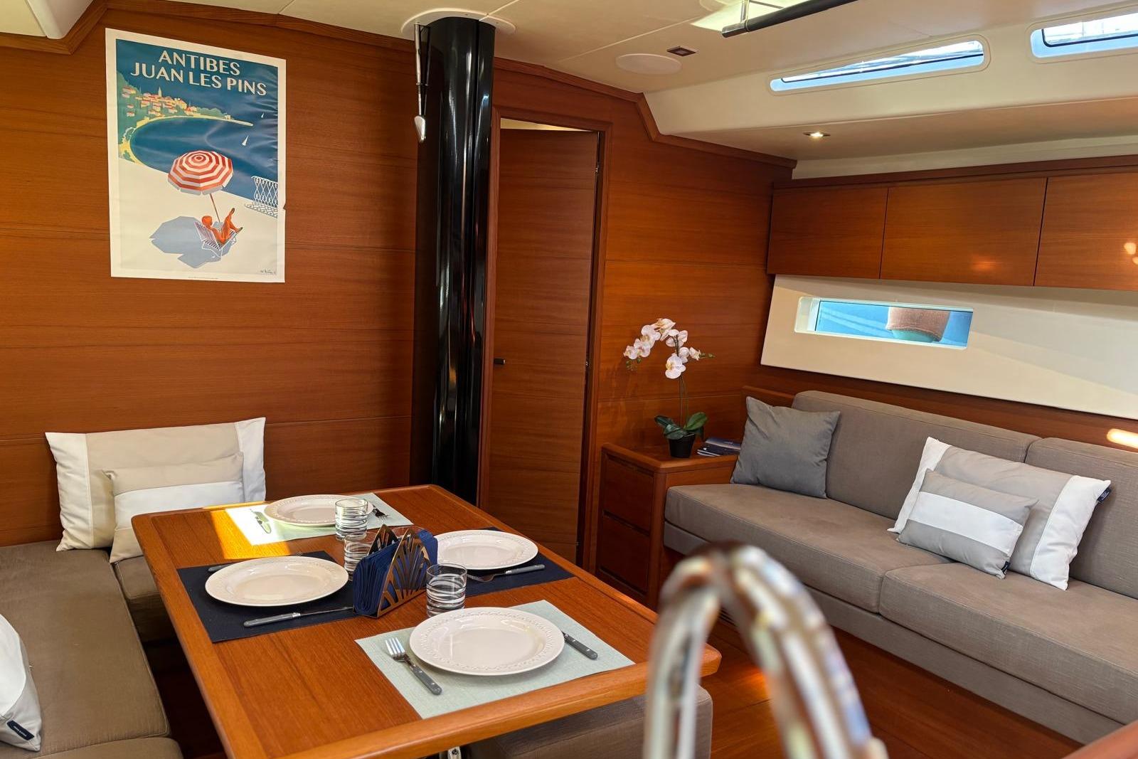 Luxurious interior of 2022 Solaris 55 yacht with elegant dining area and cozy seating.