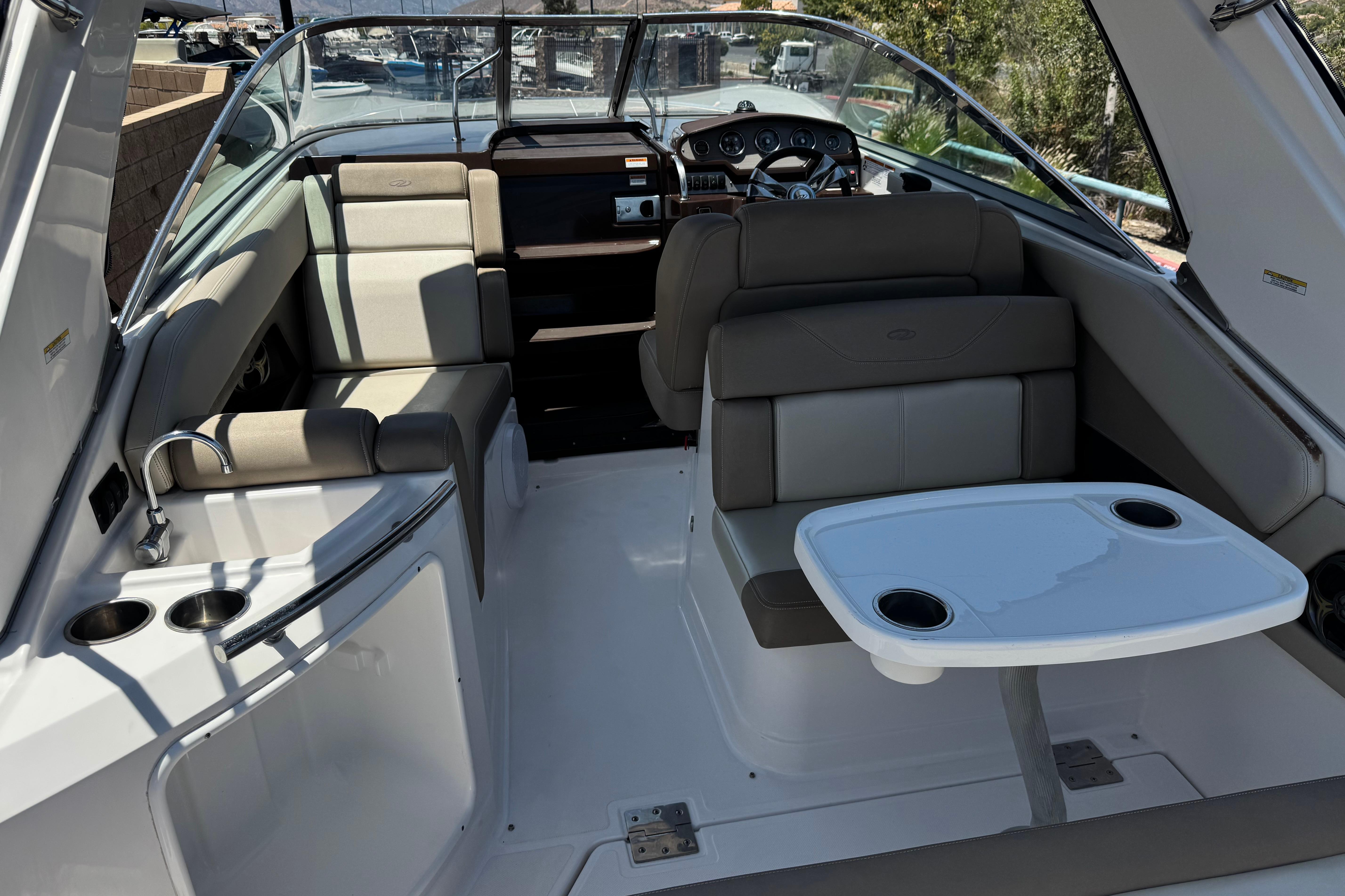 2013 Regal 28 Express boat interior with seating, table, and dashboard.