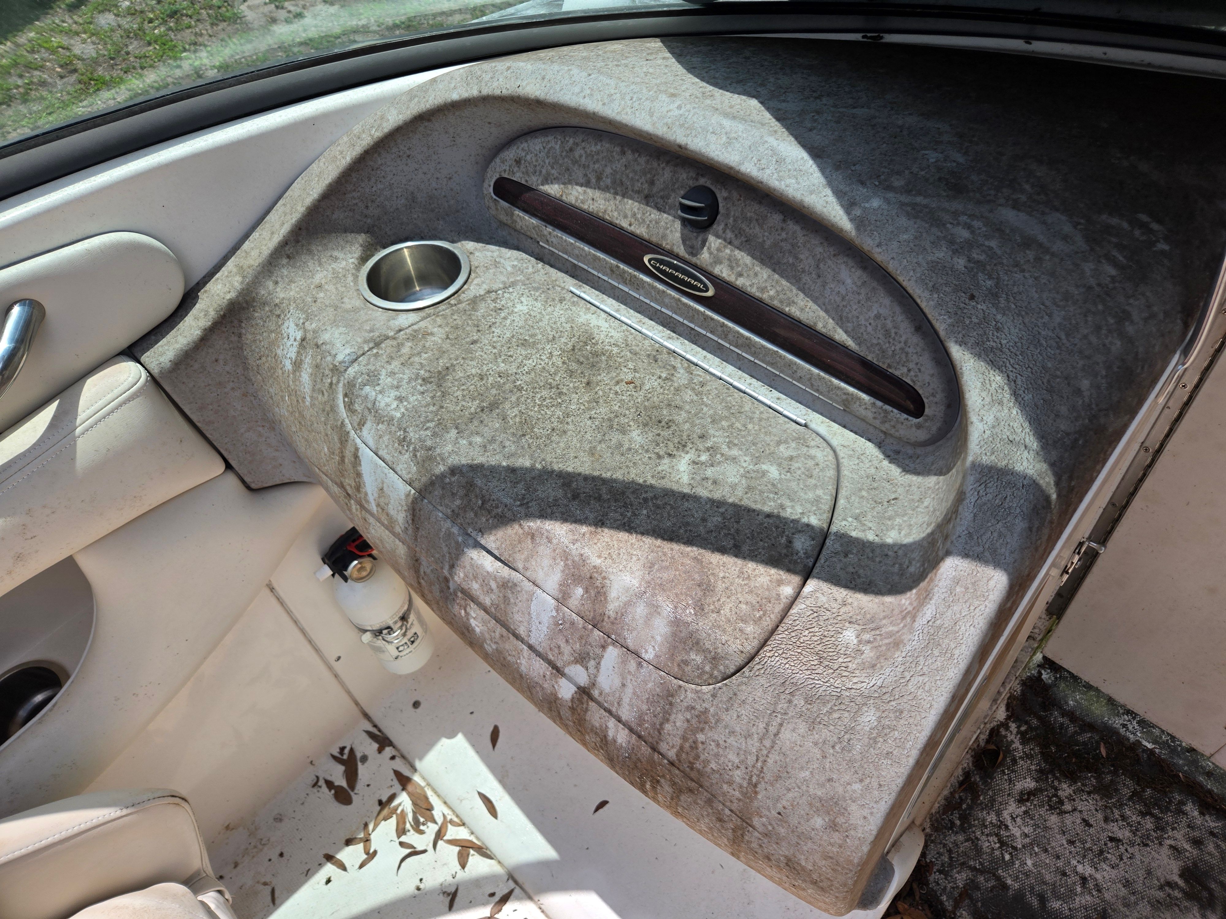 The image shows the cockpit of a 2006 Chaparral 220 SSi with a worn dashboard.