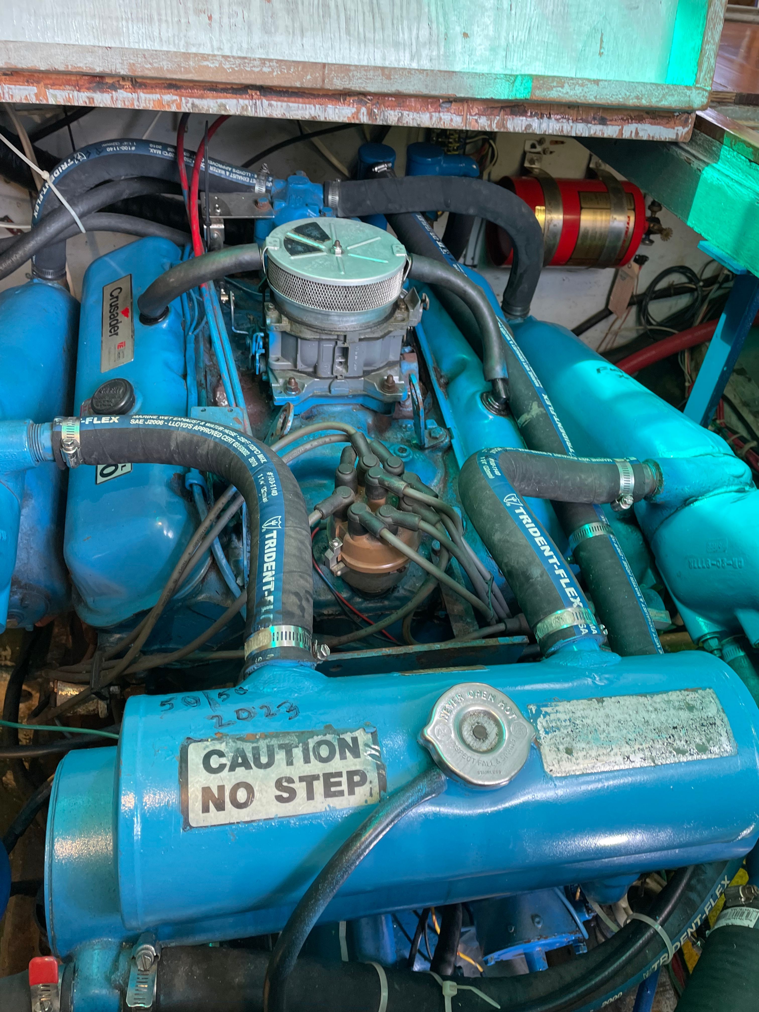 Engine compartment of a 1969 Bertram Caribe boat with blue components.